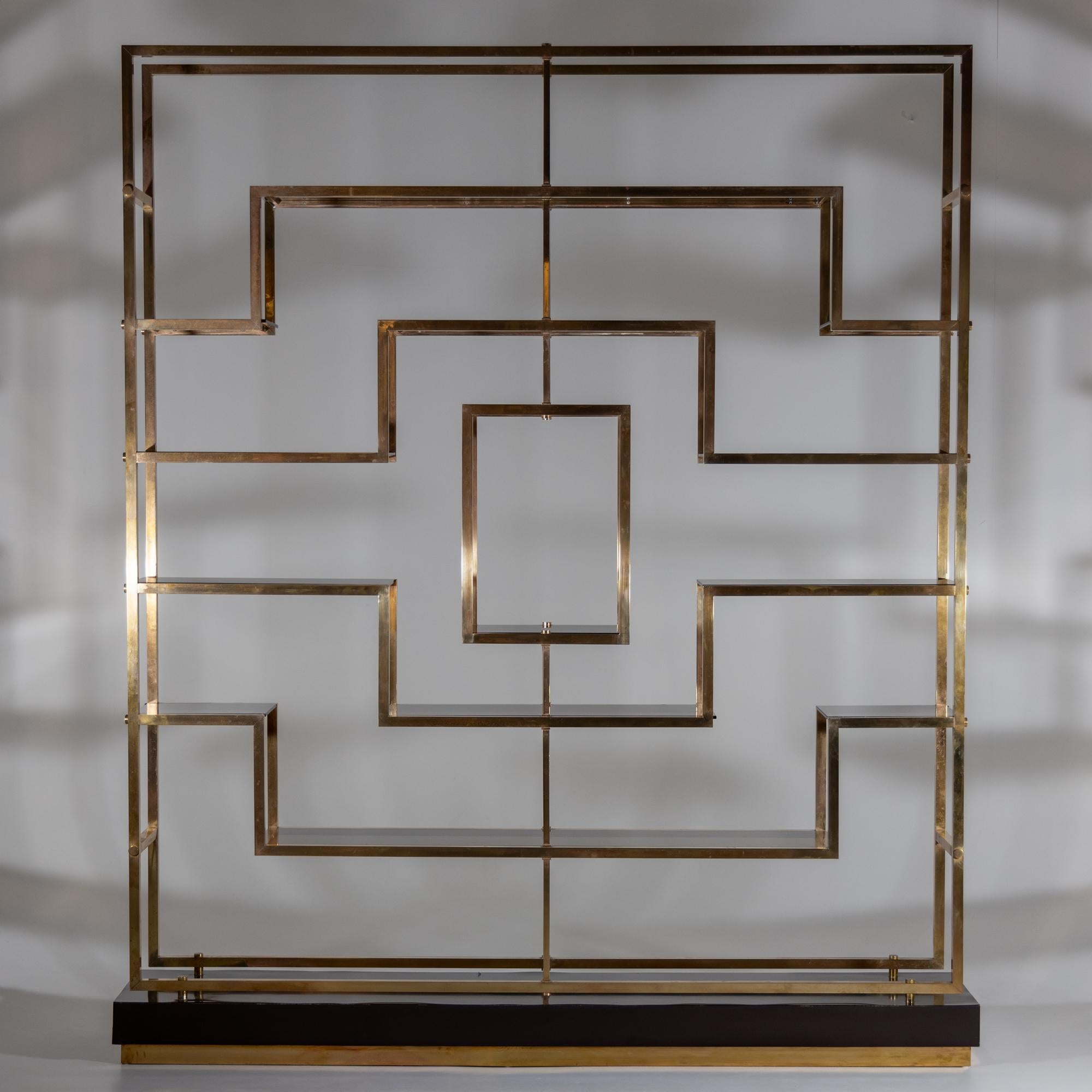 
A large brass and smoked glass etagere designed by Kim Moltzer.
Crafted in heavy brass with black base.
