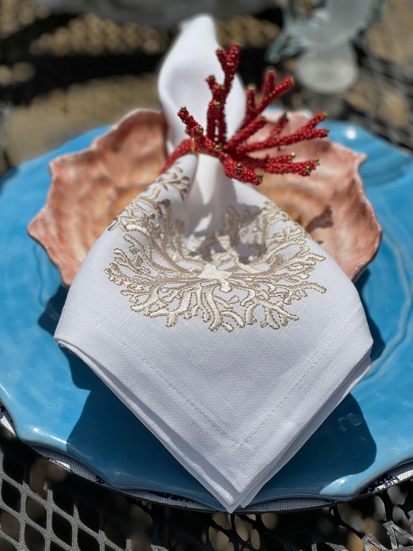 Inspired by the wonders of the sea, these beautiful Kim Seybert napkins showcase hand-drawn coral designs embroidered on a crisp white linen napkin. The embroidery comprises four different techniques; running, back, satin and French knot. Five