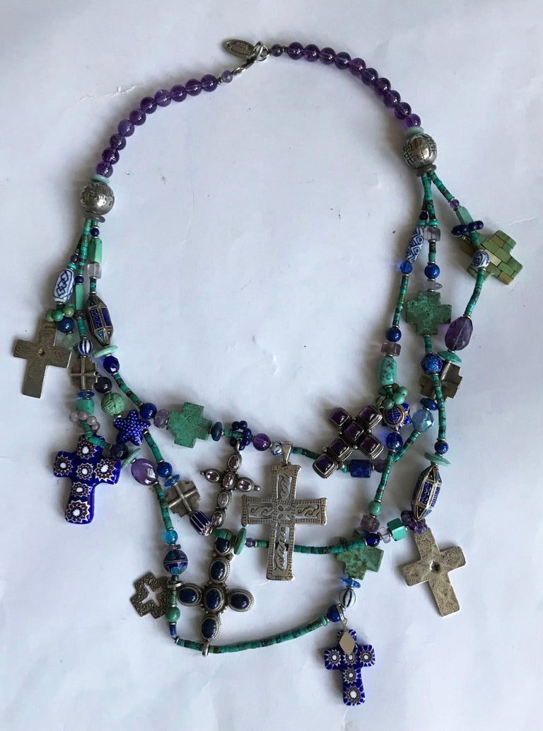  

Kim Yubeta Vintage Native American Navajo Style Turquoise Sterling necklace.
A stunning highly ornate profusely decorated necklace featuring multiple crosses and beads in sterling silver, millefiori glass, amethyst turquoise and gem stones. Each