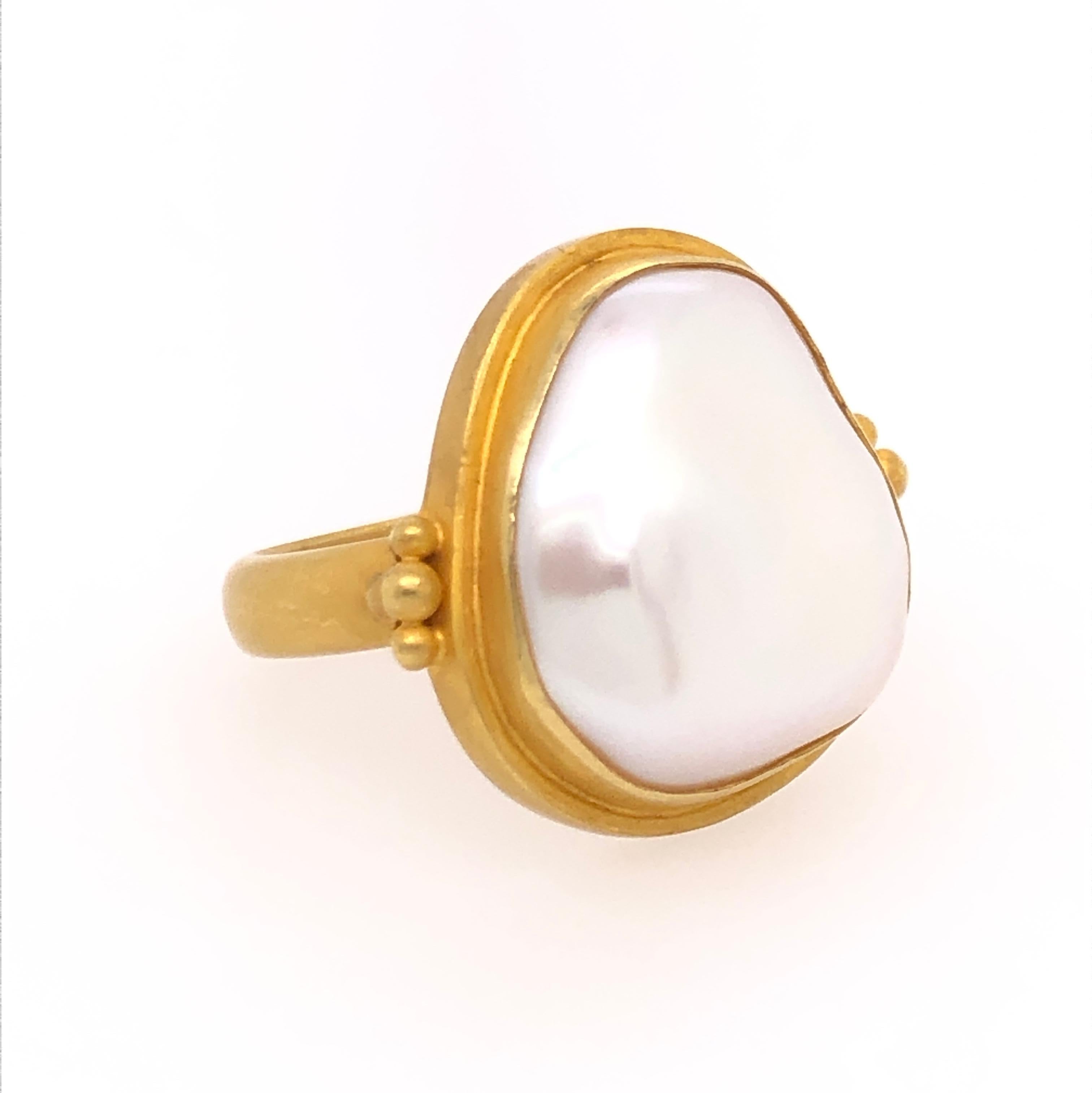 For my bohemian hearts, the beauty of this make pearl ring is in its irregularity. Kimarie designed the 18 karat yellow gold ring around the 17mm x 19mm Mabe pearl. The minimal accents of gold bring the viewer's eye directly to the Mabe pearl's