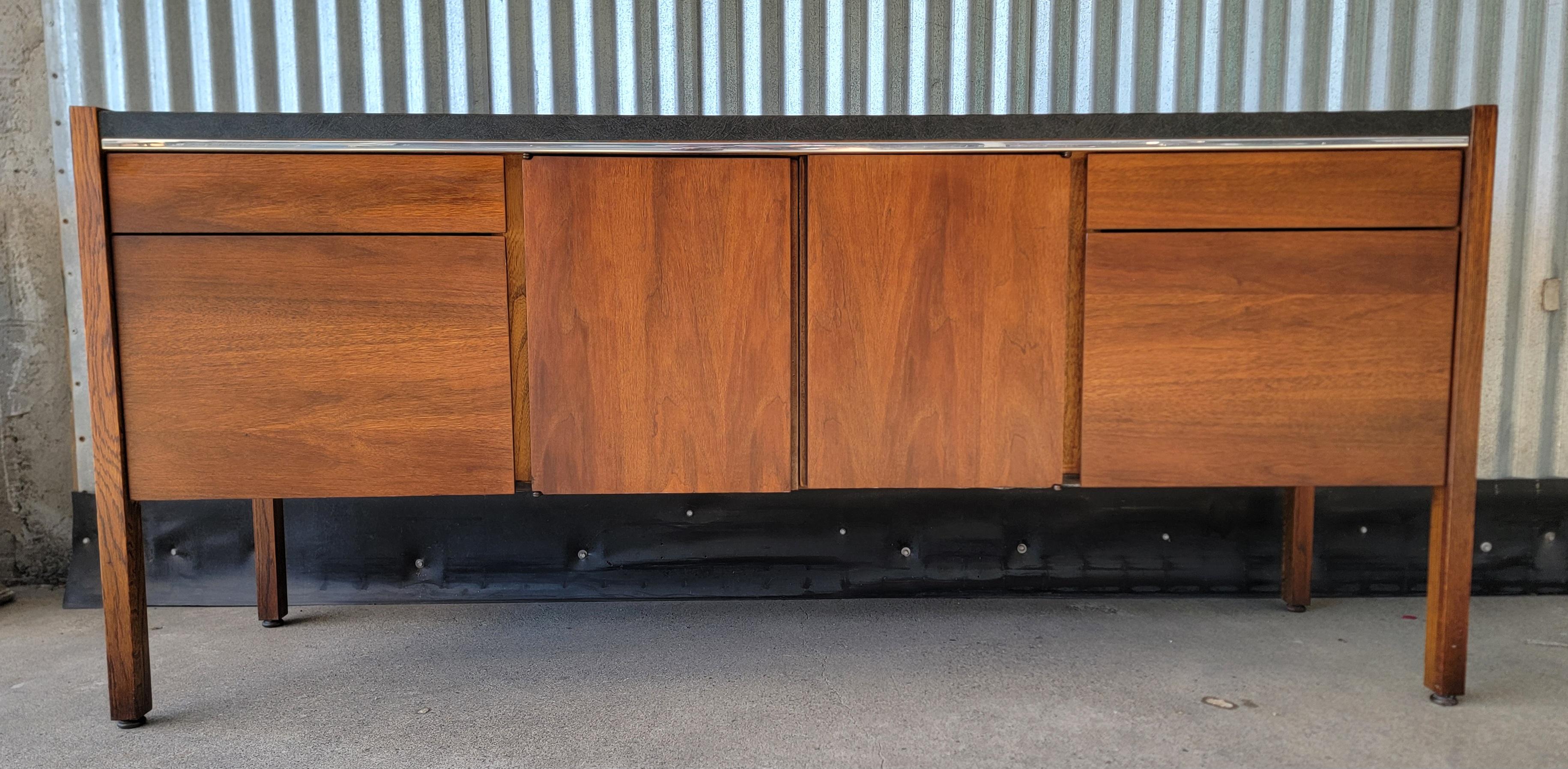 Quality craftsmanship and materials in the Kimball Furniture Office Credenza. Features 2 file drawers with 2 additional drawers and 2 door storage area in center. Formica top surface offer durability and style. Metal glides assure smooth and
