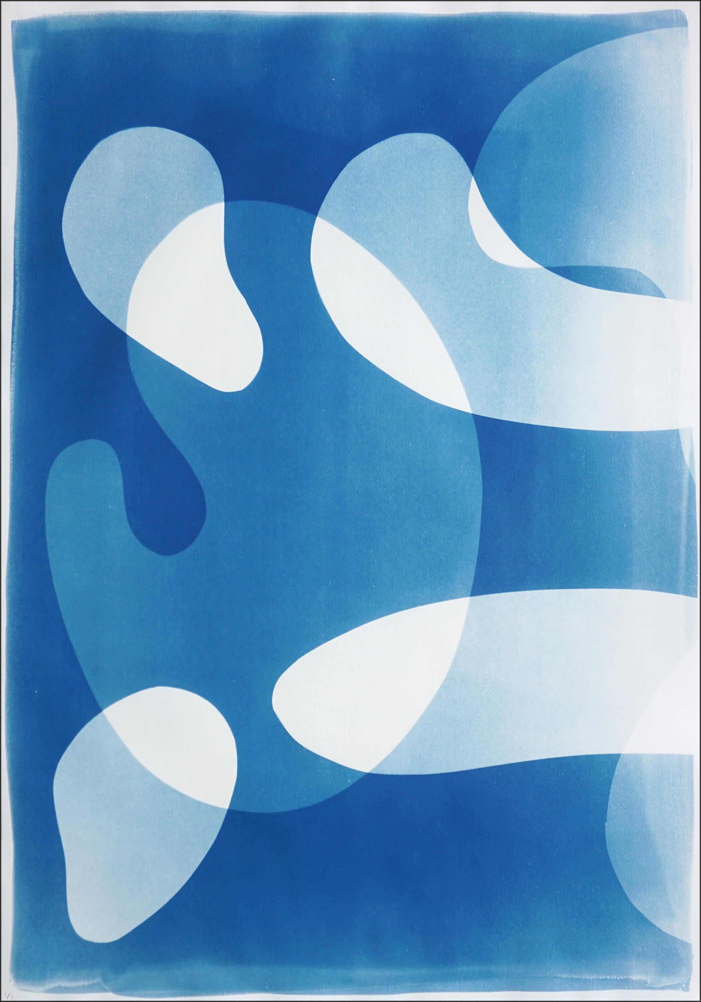 Blue Floating Mobile III is a unique handmade cyanotype on watercolor paper, presented as a striking abstract triptych. The artist layers fluid, organic shapes in luminous shades of blue and white, creating a sense of movement reminiscent of