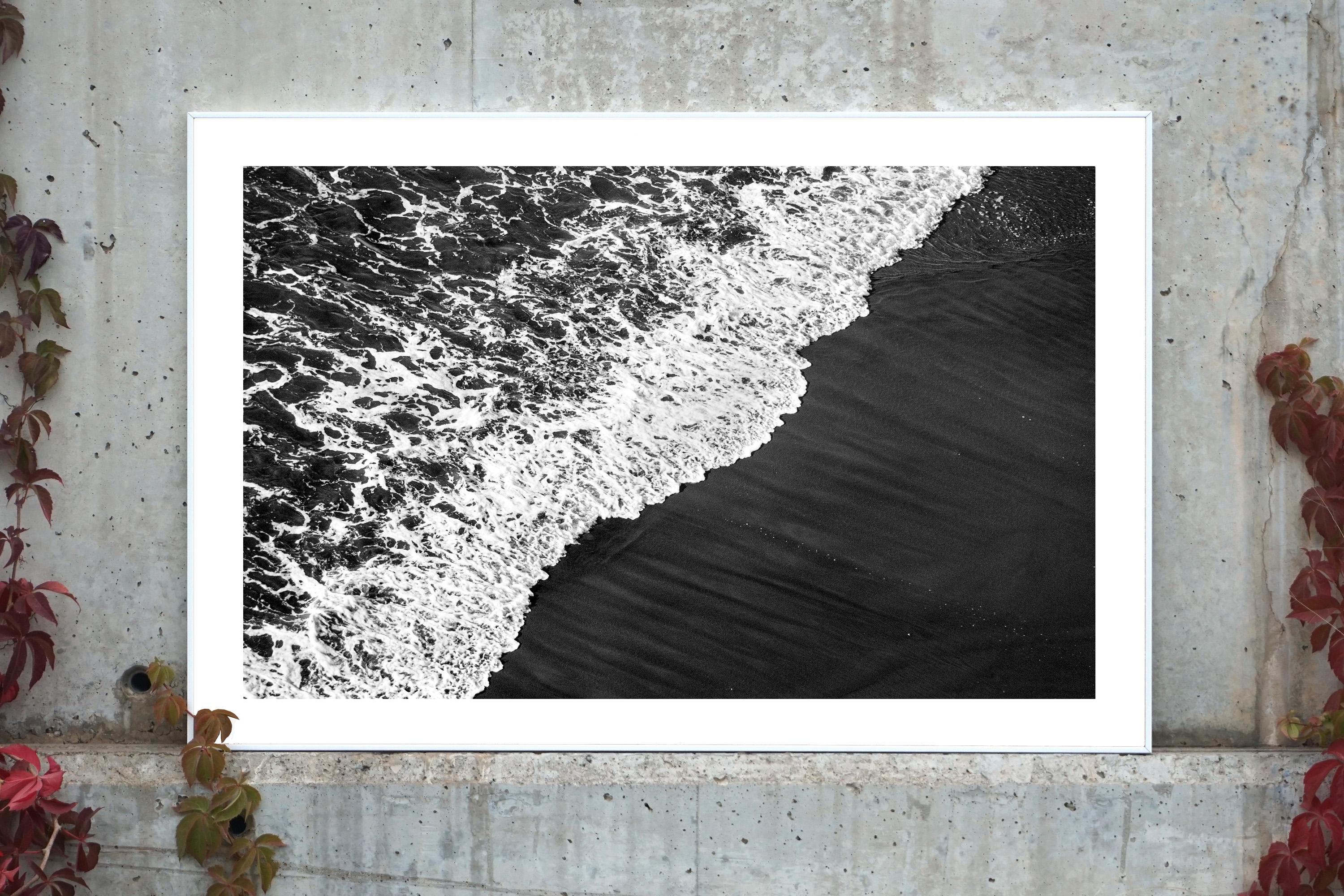 Deep Black Sandy Shore, Black and White Seascape, Smooth Wave Reaching the Coast - Photograph by Kind of Cyan
