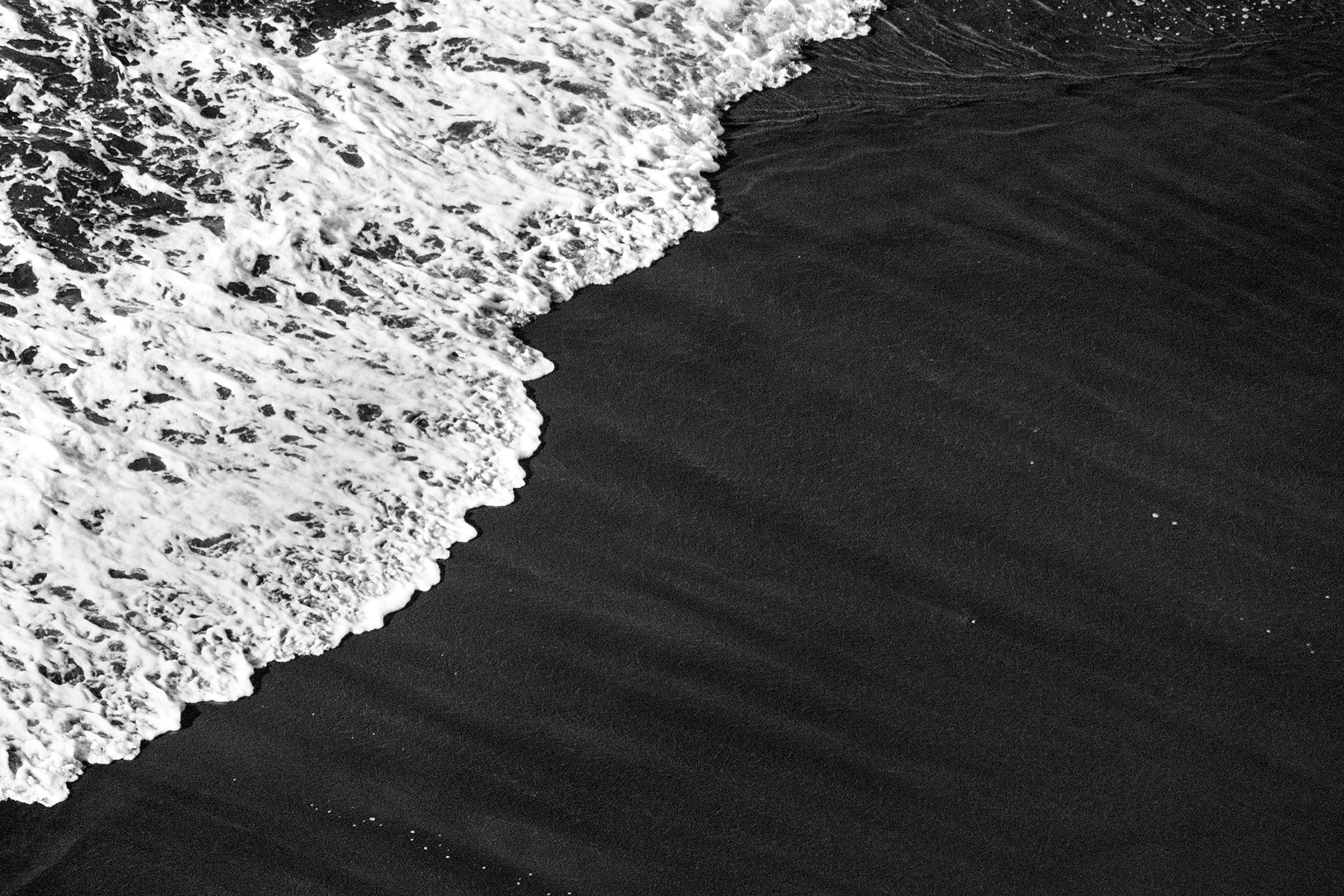Deep Black Sandy Shore, Black and White Seascape, Smooth Wave Reaching the Coast For Sale 1