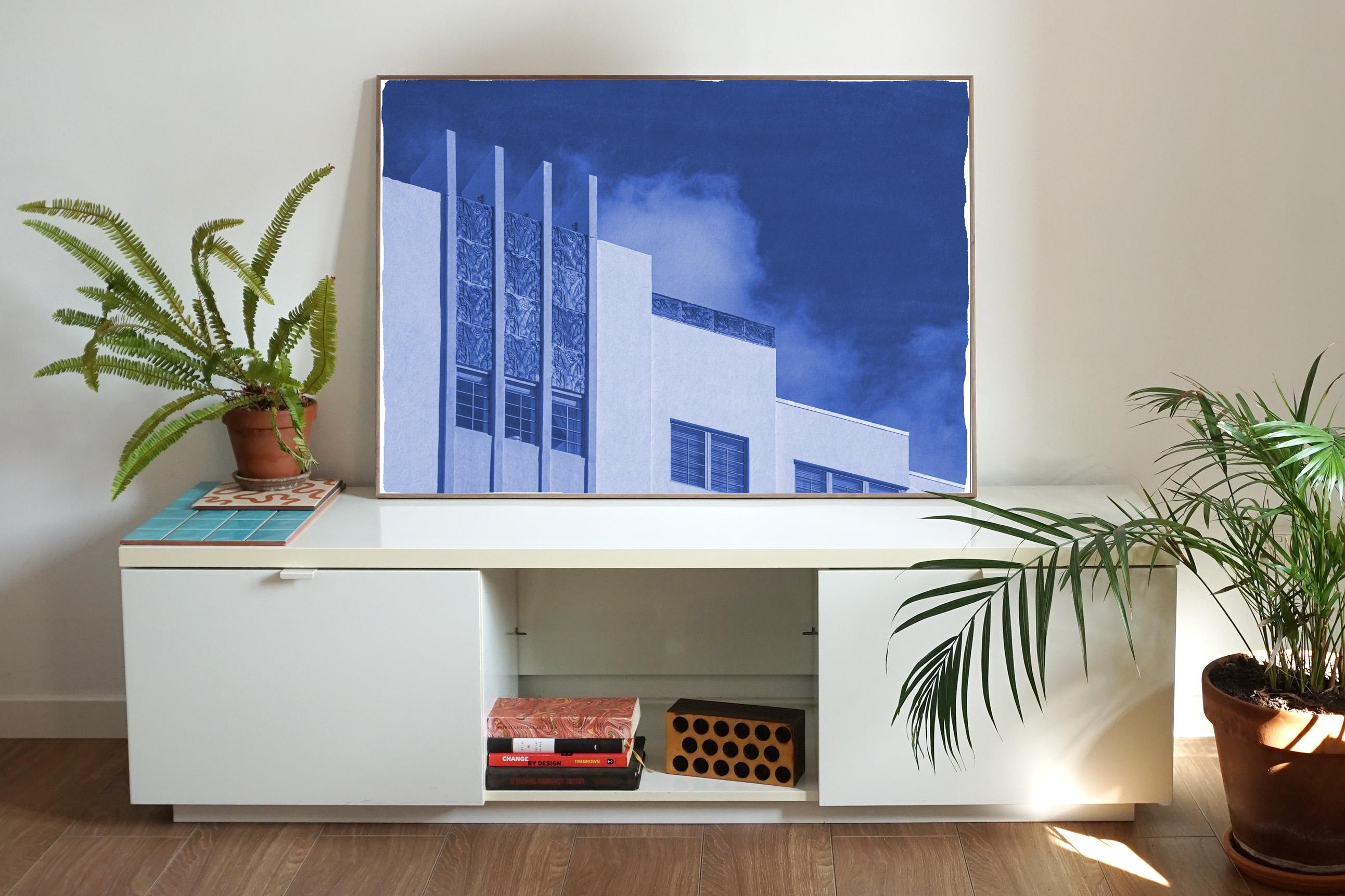 This is an exclusive handprinted limited edition cyanotype. 
This beautiful cyanotype portrays an iconic building facade from the thirties. 

Details:
+ Title: Thirties Building with Sky
+ Year: 2021
+ Edition Size: 100
+ Stamped and Certificate of