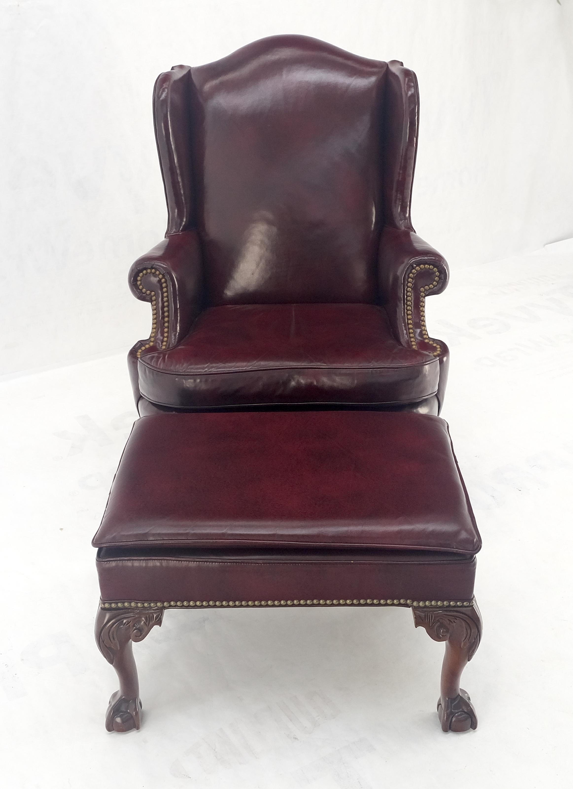 Kindel Burgundy Leather Upholstery Carved Mahogany Legs Wingback Chair & Ottoman In Good Condition For Sale In Rockaway, NJ