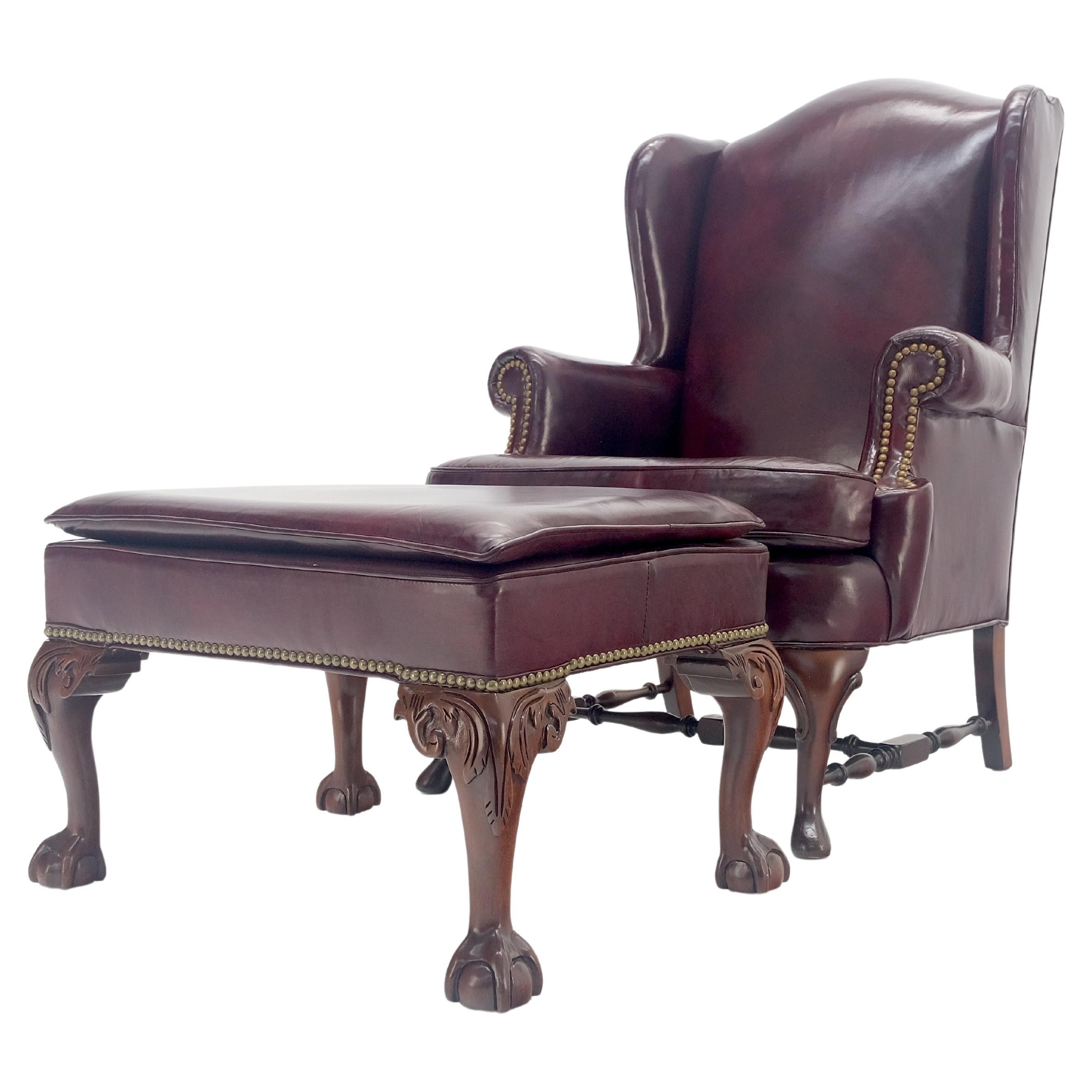 Kindel Burgundy Leather Upholstery Carved Mahogany Legs Wingback Chair & Ottoman For Sale
