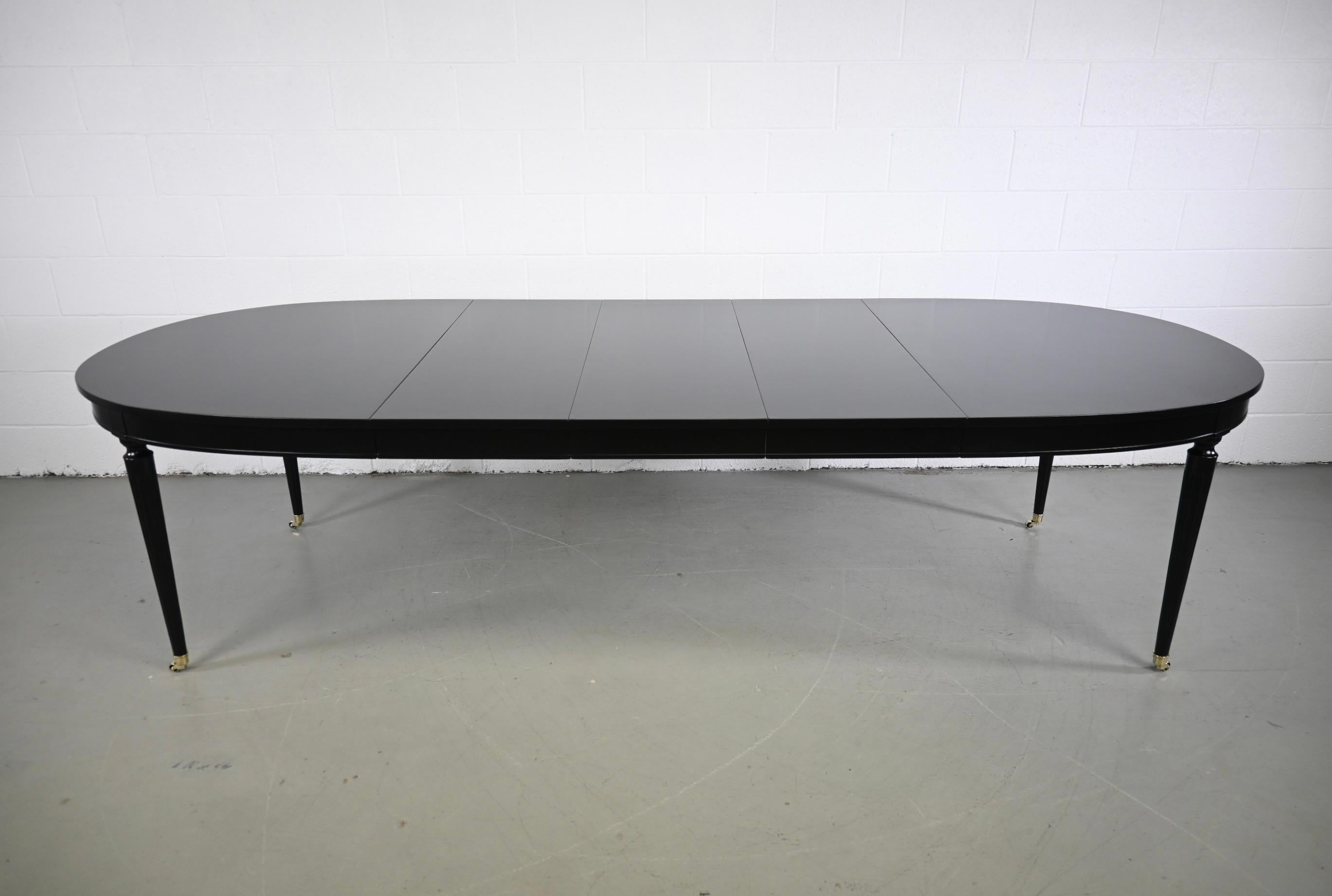 Kindel Furniture Black Lacquered French Regency Style Extension Dining Table

Kindel Furniture, USA, 1970s

65.75 Wide x 44 Deep x 29 High. Table extends up to 113.75
