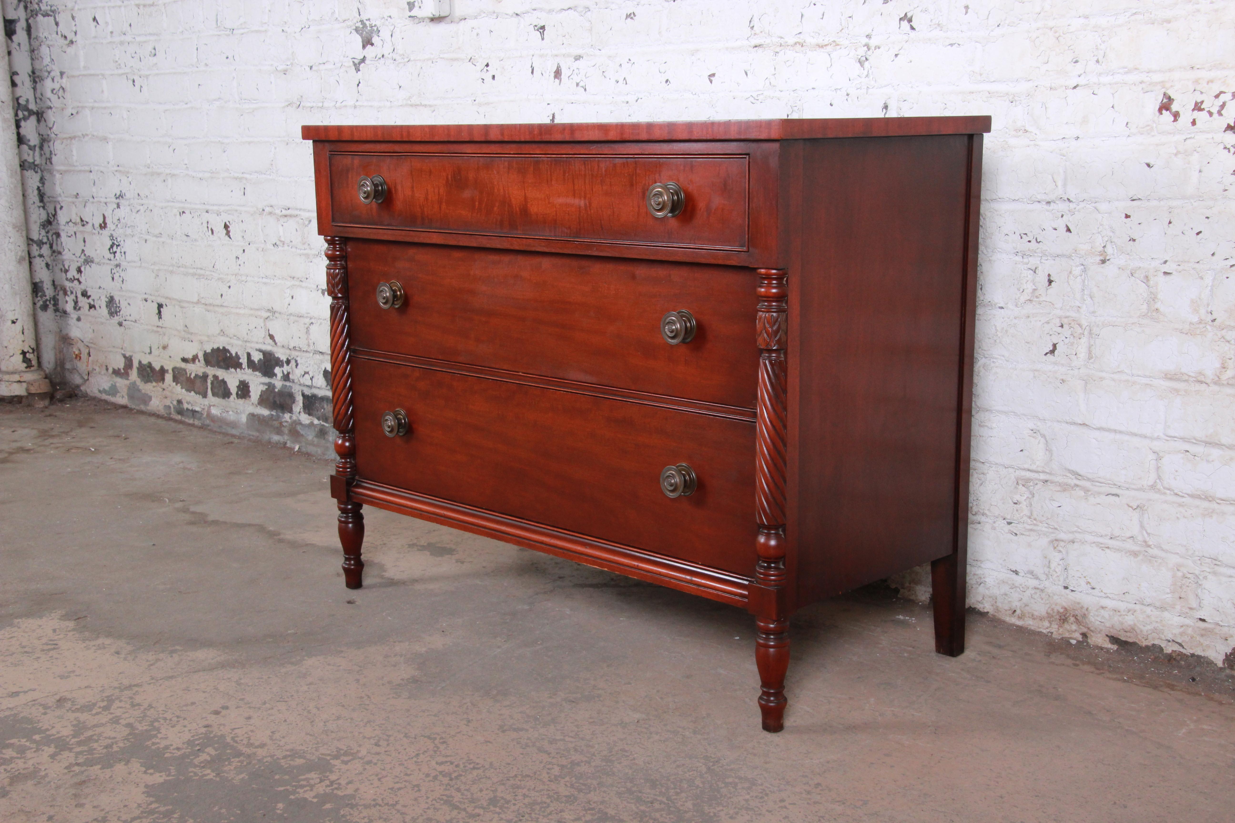 A gorgeous carved mahogany chest of drawers by Kindel Furniture of Grand Rapids. The dresser features beautiful mahogany wood grain in the 