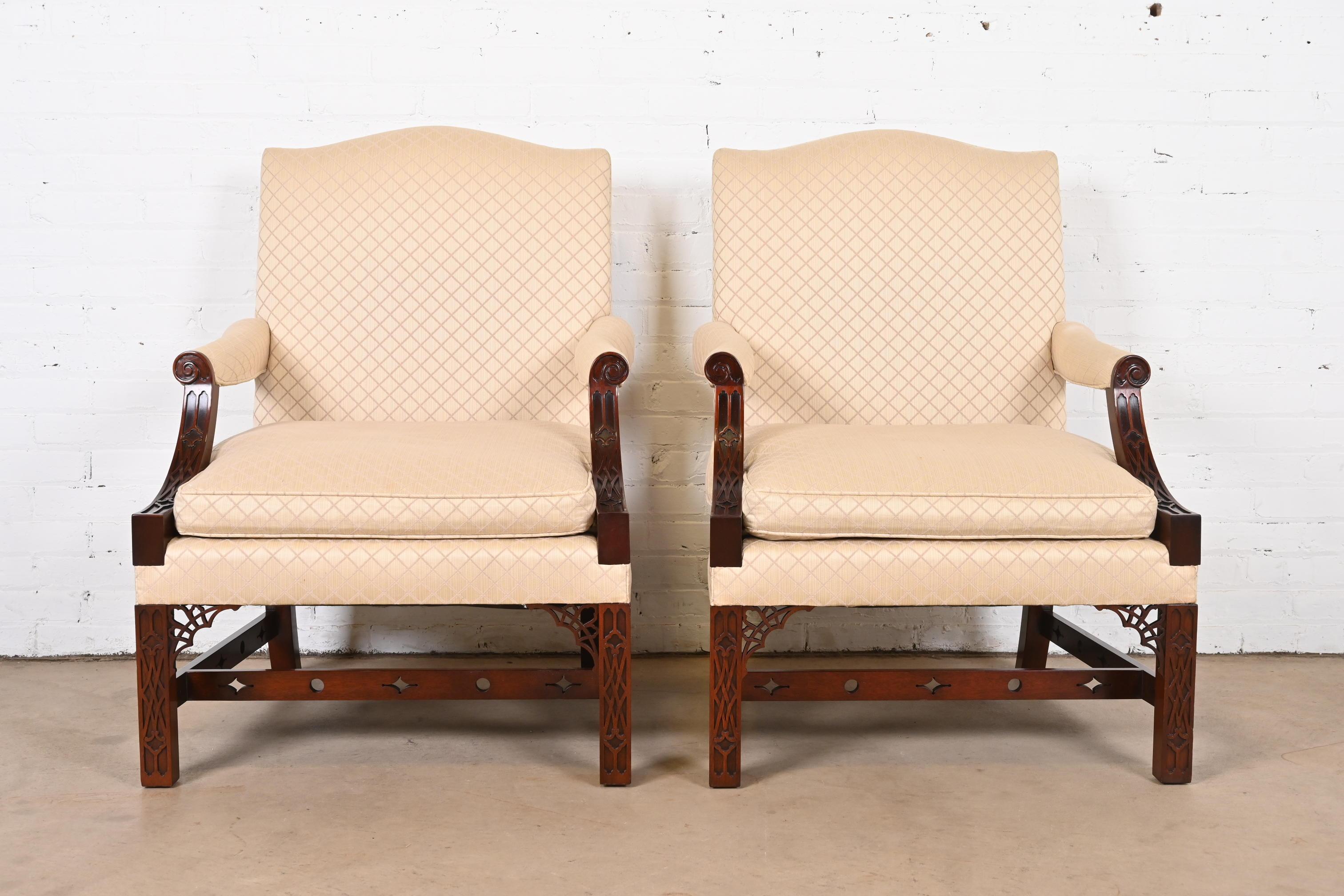A gorgeous pair of English Chippendale style upholstered library chairs, bergere chairs, or lounge chairs

By Kindel Furniture

USA, Late 20th Century

Beautiful carved mahogany frames, with cream diamond patterned upholstery,

Measures: 28.13