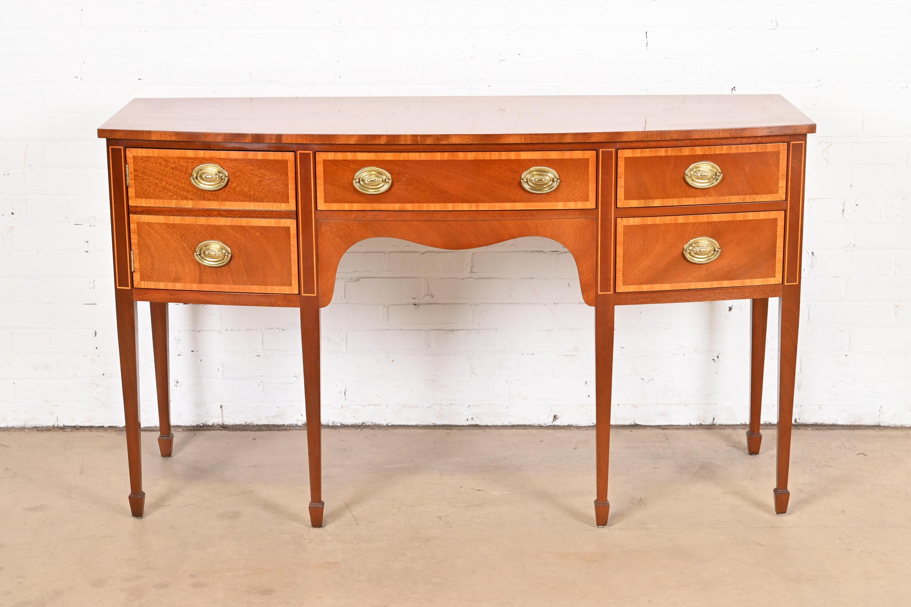 A gorgeous Federal or Hepplewhite style bow front sideboard buffet or credenza

By Kindel Furniture

USA, Circa 1980s

Mahogany, with satinwood banding and original brass hardware.

Measures: 60