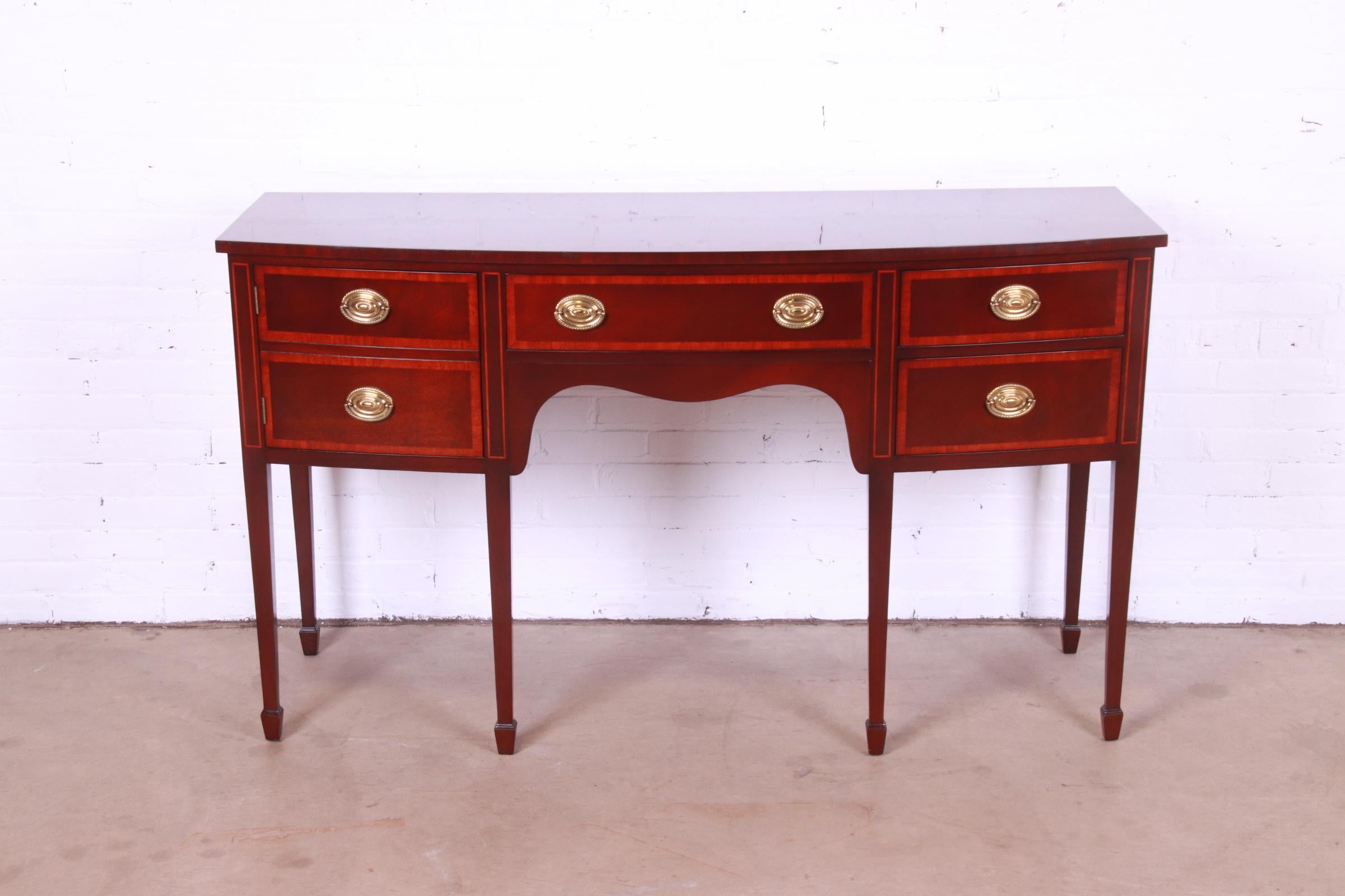 A gorgeous Federal or Hepplewhite style bow front sideboard buffet or credenza

By Kindel Furniture

USA, Circa 1980s

Mahogany, with satinwood banding and original brass hardware.

Measures: 60