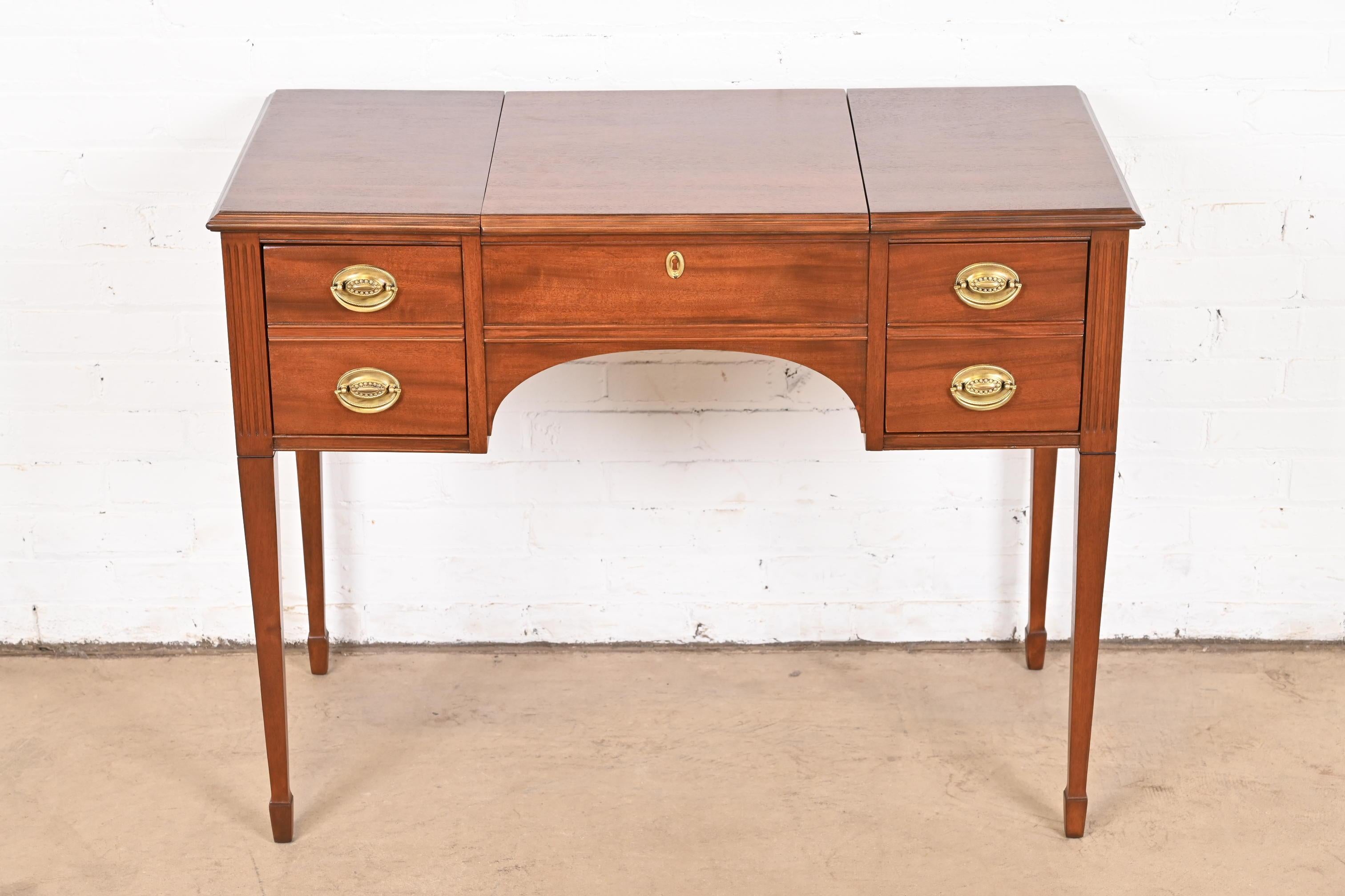 A gorgeous Georgian or Federal style vanity with flip-up mirror

By Kindel Furniture

USA, Circa 1960s

Mahogany, with original brass hardware.

Measures: 38