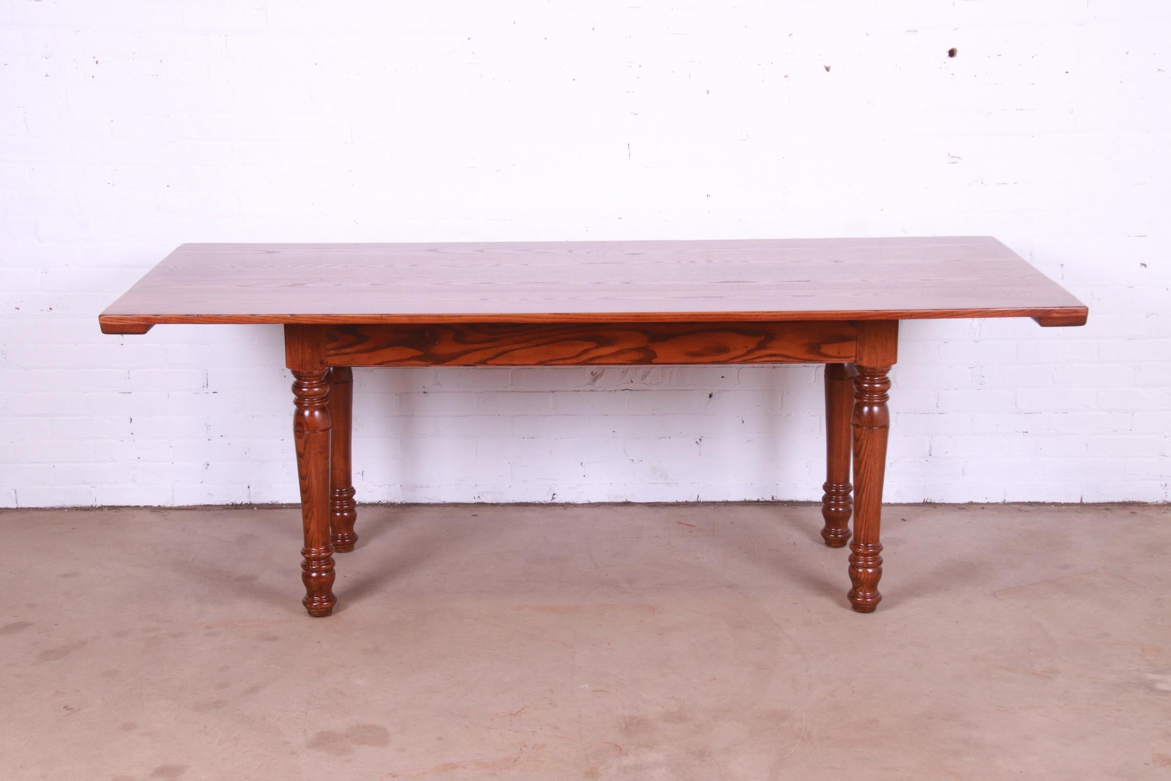 A gorgeous French Country or French Provincial style farmhouse harvest dining table

By Kindel Furniture

USA, Mid-20th Century

Solid oak slab top, with turned solid oak legs.

Measures: 84