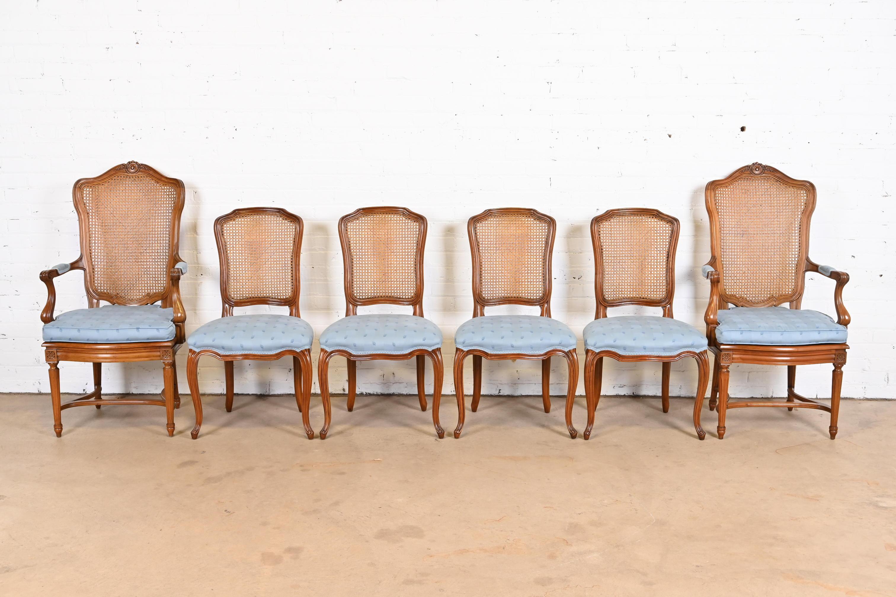A gorgeous set of six French Louis XVI style dining chairs

By Kindel Furniture

USA, 1960s

Carved solid cherry wood, with caned backs and upholstered seats.

Measures:
Side chairs - 20