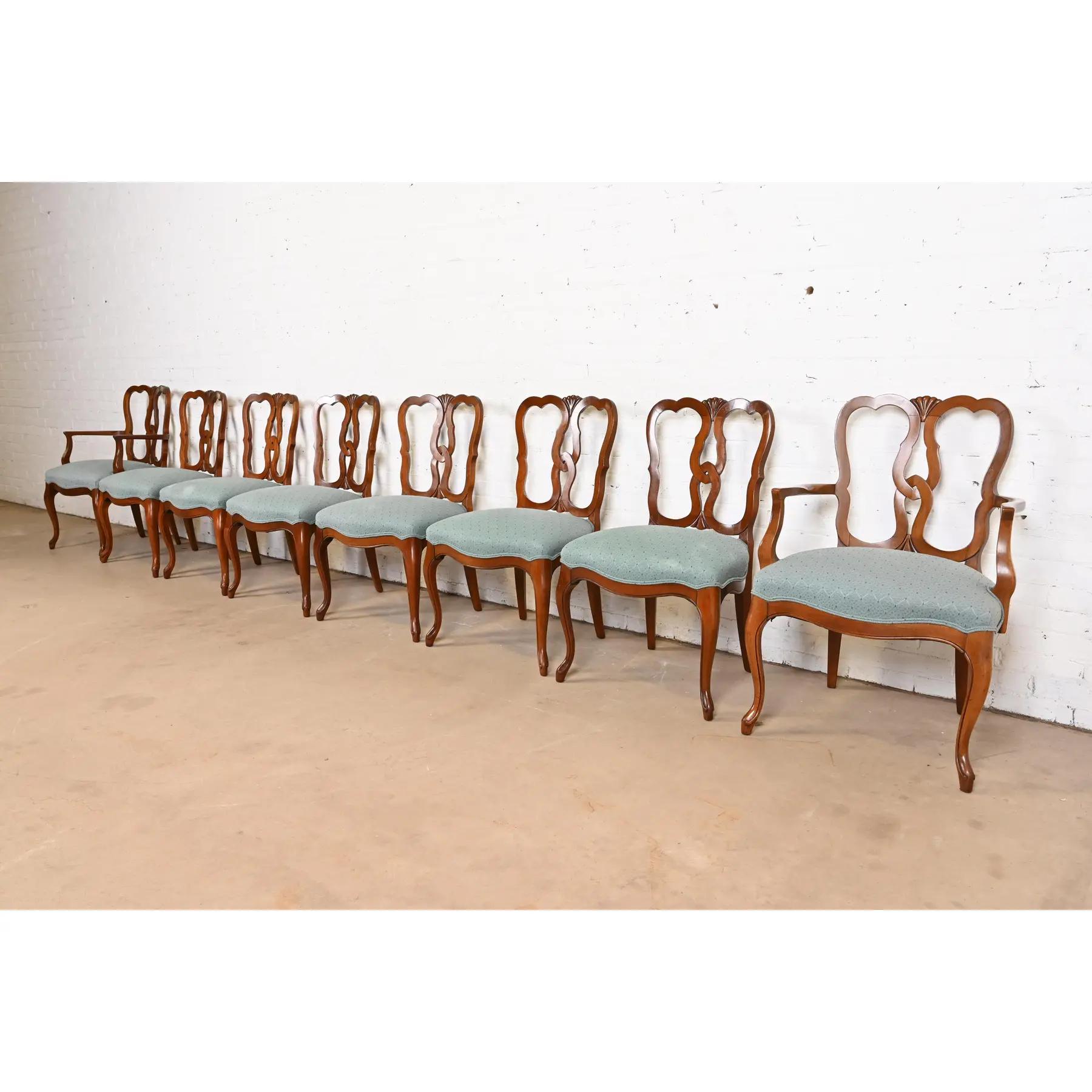 A gorgeous set of eight French Provincial Louis XV style dining chairs

By Kindel Furniture

USA, Circa 1960s

Solid carved cherry wood frames, with upholstered seats.

Measures:
Side Chairs - 22.25