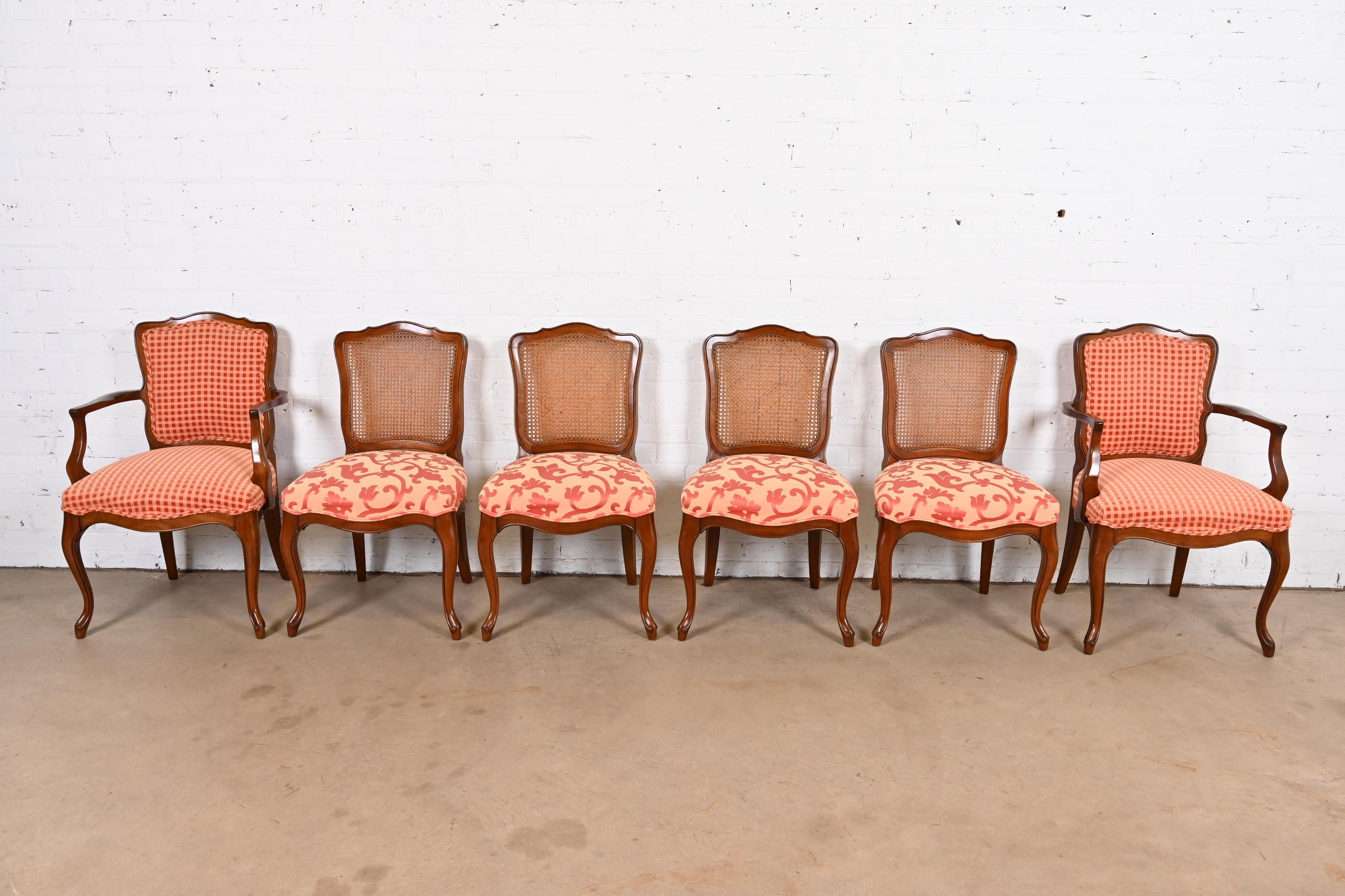 A gorgeous set of six French Provincial Louis XV style dining chairs

By Kindel Furniture

USA, Circa 1960s

Carved solid cherry wood frames, with caned backs and upholstered seats.

Measures:
Side chairs - 20.5