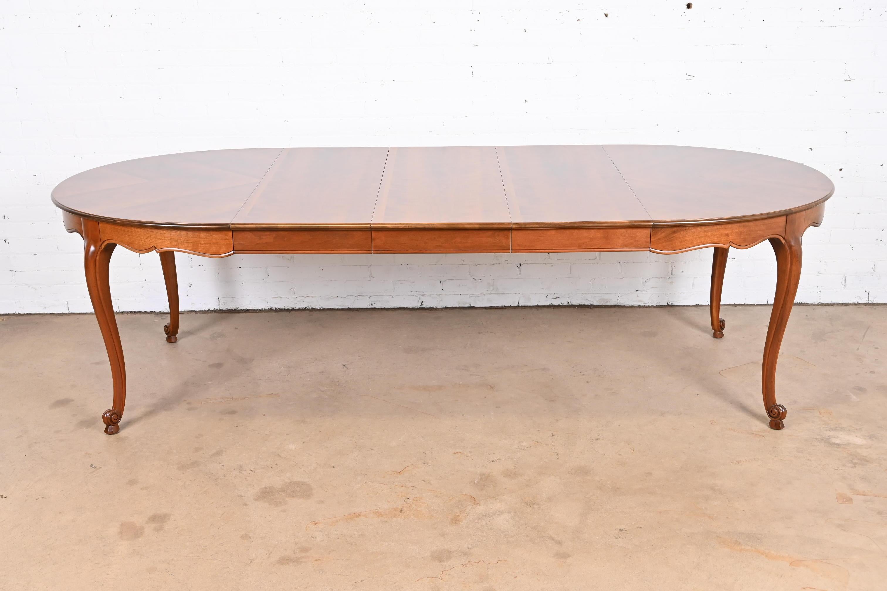 An exceptional French Provincial Louis XV style extension dining table

By Kindel Furniture

USA, Circa 1970s

Stunning book-matched inlaid cherry wood top, with carved solid cherry wood cabriole legs.

Measures: 53.75