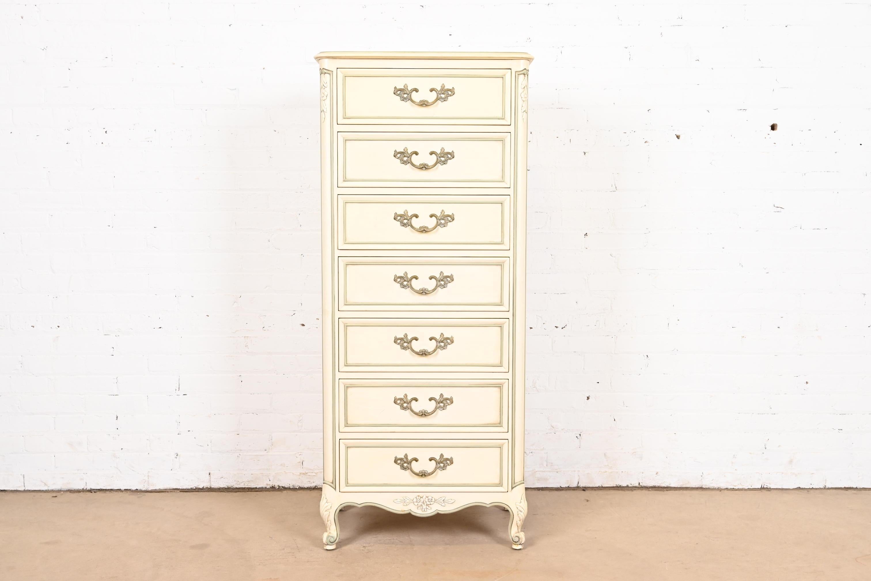 A gorgeous French Provincial Louis XV style seven-drawer lingerie chest or semainier

By Kindel Furniture

USA, Circa 1960s

Carved cream lacquered cherry wood, with olive green trim, and original brass hardware.

Measures: 23.38