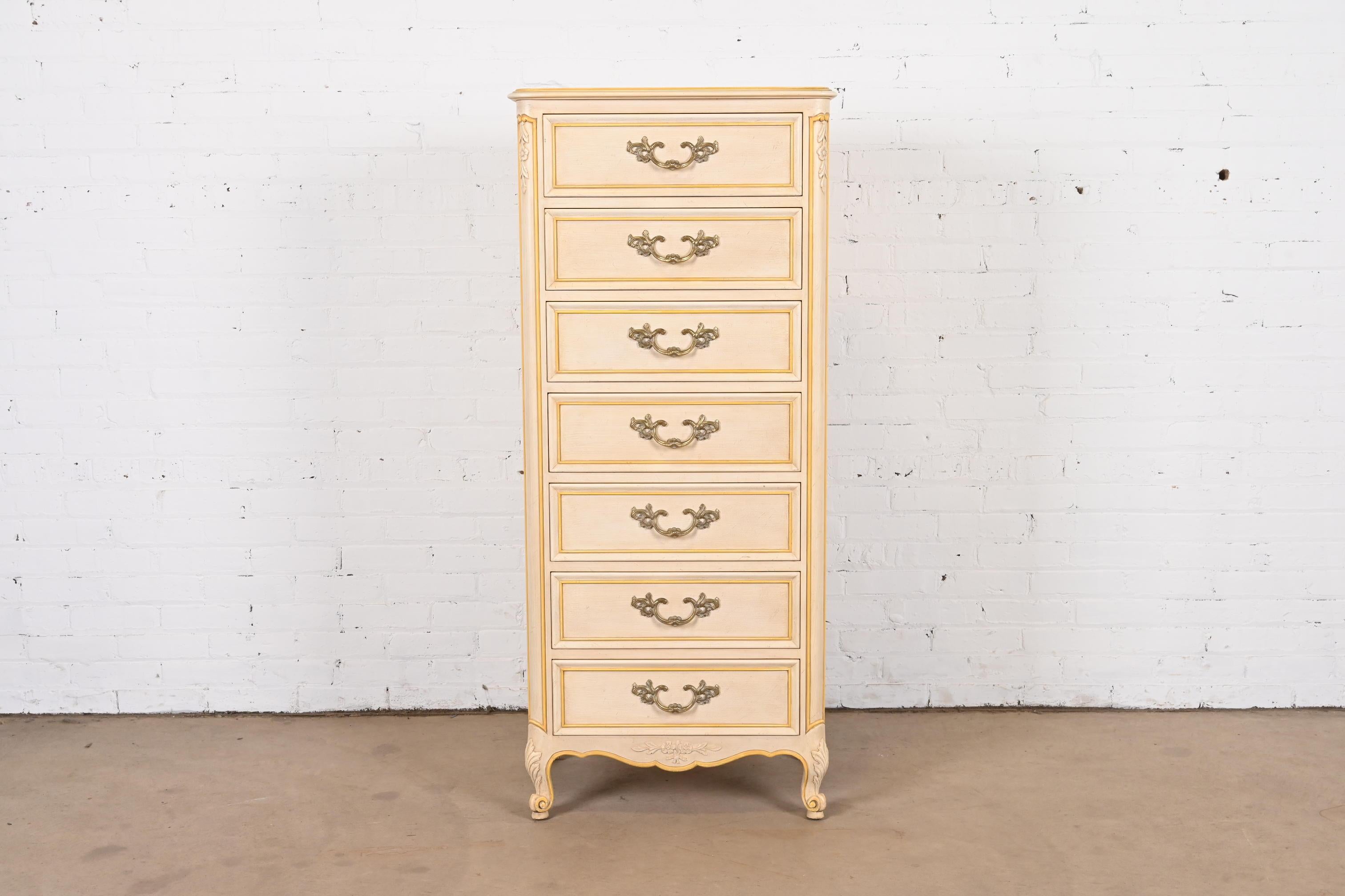 A gorgeous French Provincial Louis XV style seven-drawer semainier or lingerie chest

By Kindel Furniture

USA, Circa 1960s

Cream painted carved solid cherry wood, with gold gilt painted trim, and original brass hardware.

Measures: 24.13