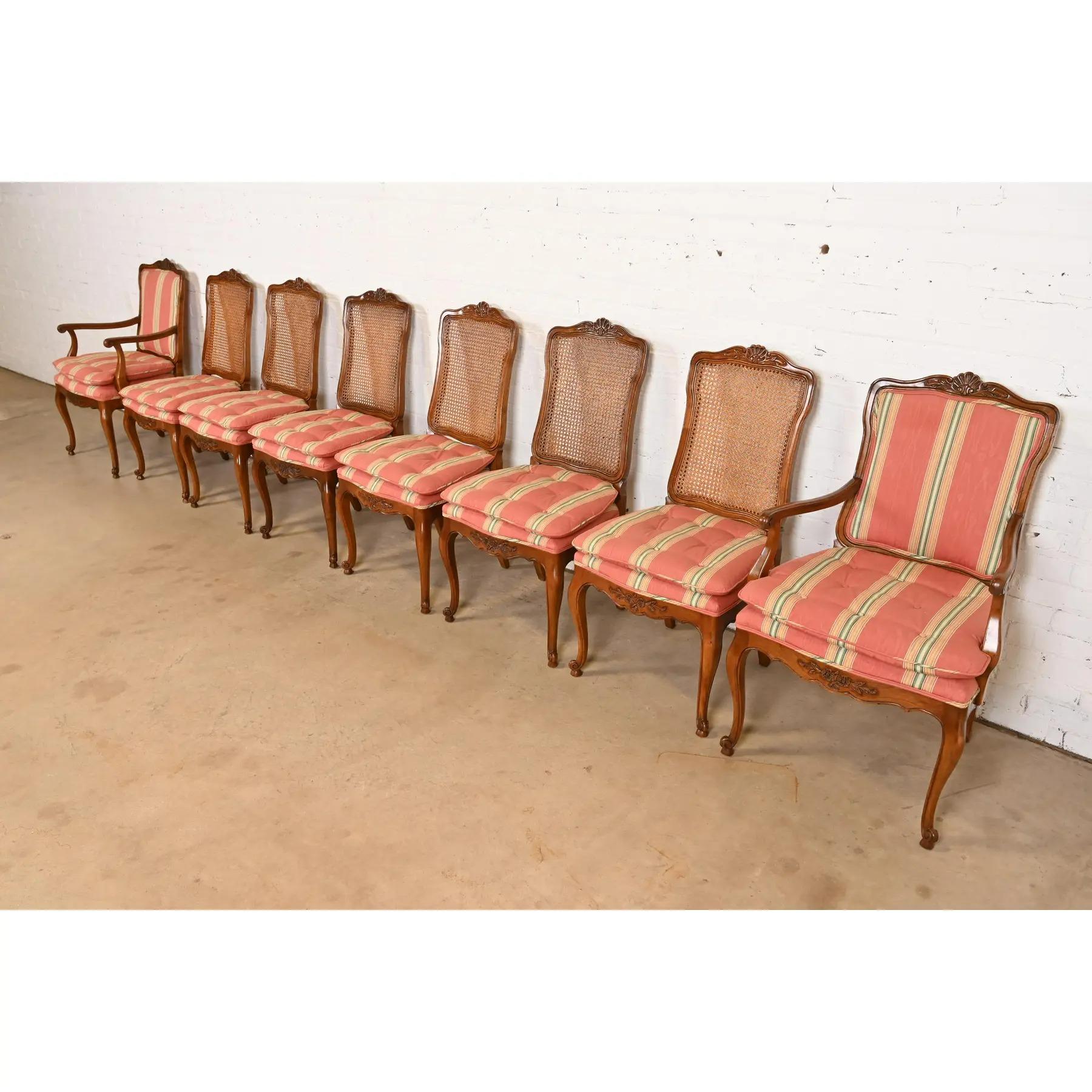 A gorgeous set of eight French Provincial Louis XV style dining chairs

By Kindel Furniture

USA, Circa 1980s

Carved solid walnut frames, with caned backs and upholstered seats.

Measures: 
Side chairs - 20.5