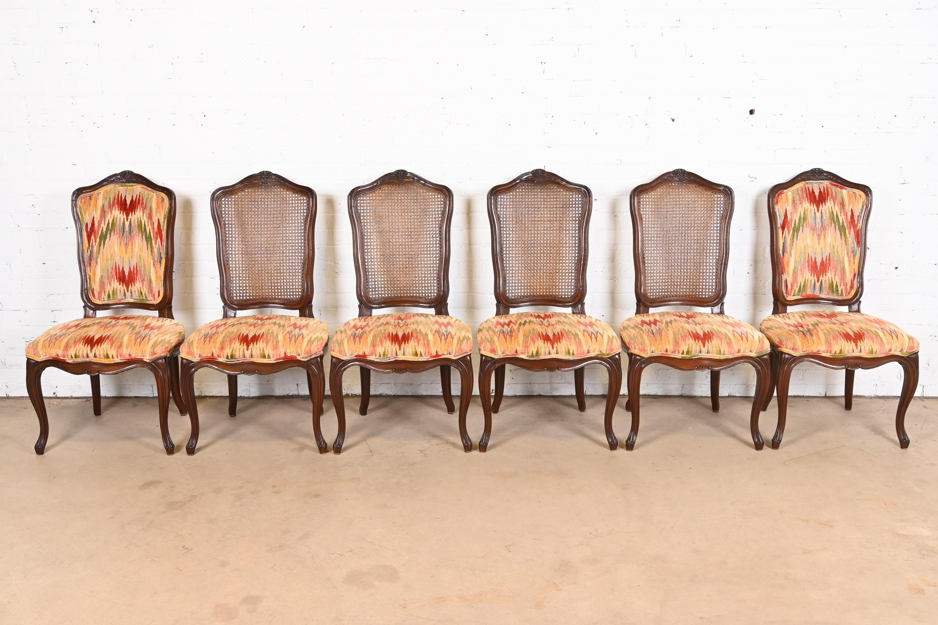 A gorgeous set of six French Provincial Louis XV style dining chairs

By Kindel Furniture

USA, 1970s

Carved solid walnut frames, with caned backs and upholstered seats.

Measures: 22