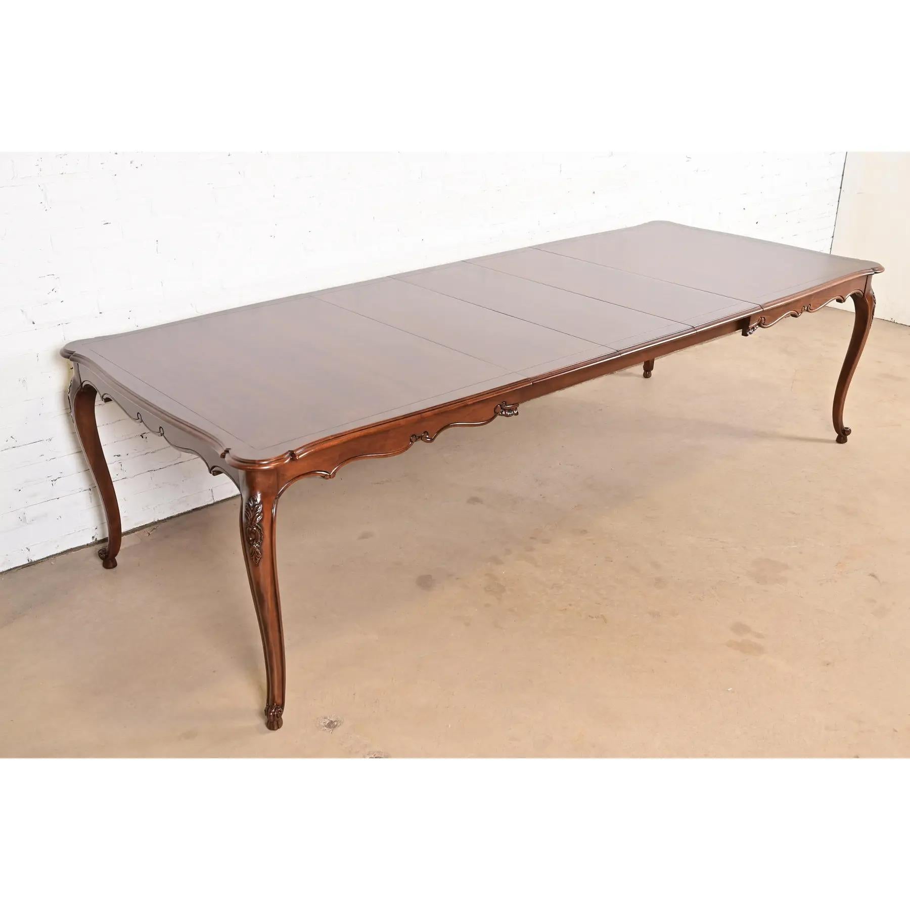 An exceptional French Provincial Louis XV style extension dining table

By Kindel Furniture

USA, Circa 1980s

Stunning book-matched burled walnut top, with carved solid walnut cabriole legs. A unique design, with leaves that store inside the