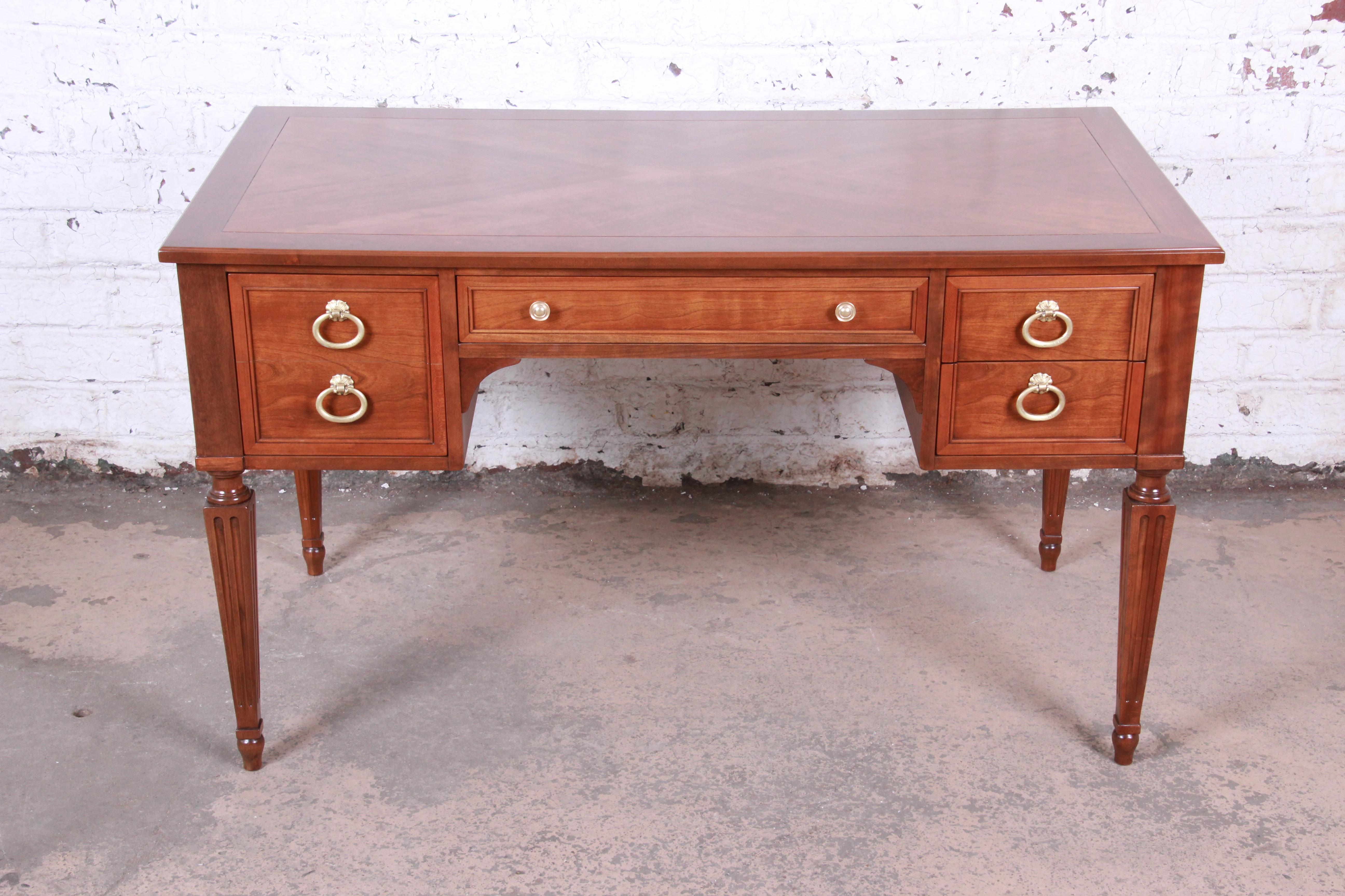 A gorgeous midcentury French Regency style writing desk

By Kindel Furniture

USA, circa 1960s

Bookmatched cherrywood and original brass hardware

Measures: 50
