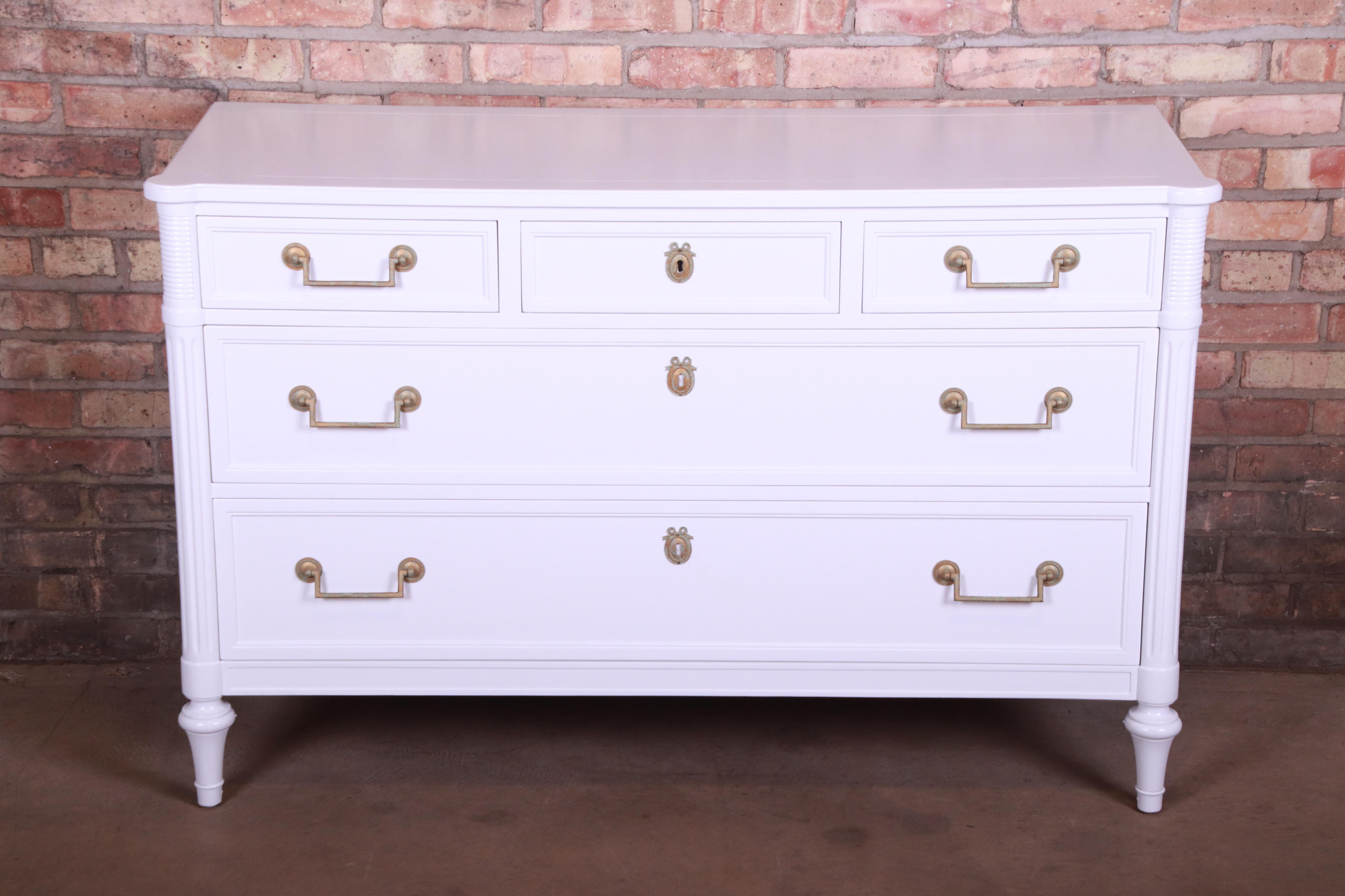 A gorgeous French Regency Directoire style five-drawer dresser or credenza

By Kindel Furniture

USA, circa 1960s

White lacquered solid cherrywood, with original brass hardware.

Measures: 50.13