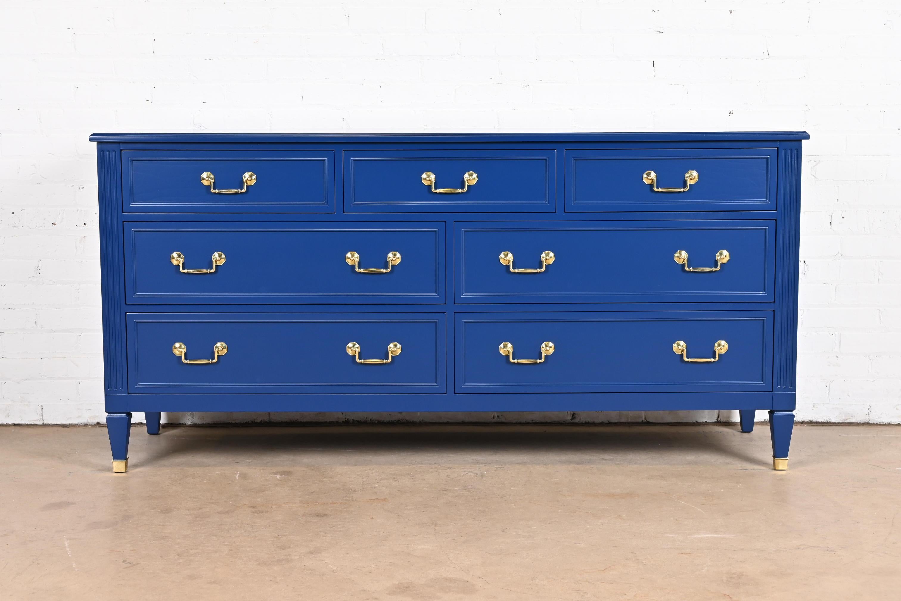 A gorgeous mid-century French Regency Louis XVI style seven-drawer dresser or credenza

By Kindel Furniture

USA, Circa 1960s

Solid cherry wood in blue lacquer, with original brass hardware and brass capped feet.

Measures: 68