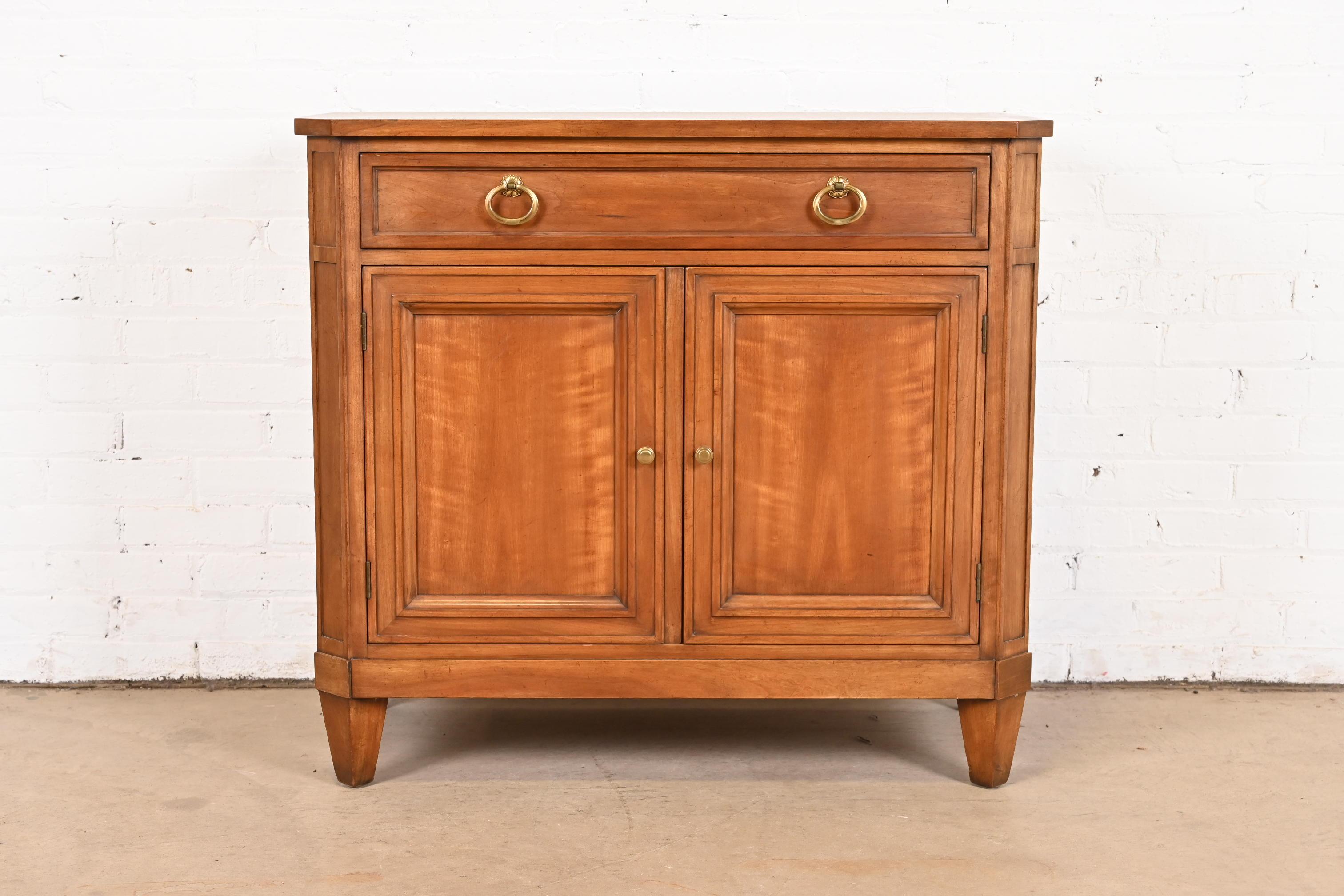 A gorgeous mid-century French Regency Louis XVI style server or bar cabinet

By Kindel Furniture

USA, Circa 1960s

Solid cherry wood, with original brass hardware.

Measures: 36