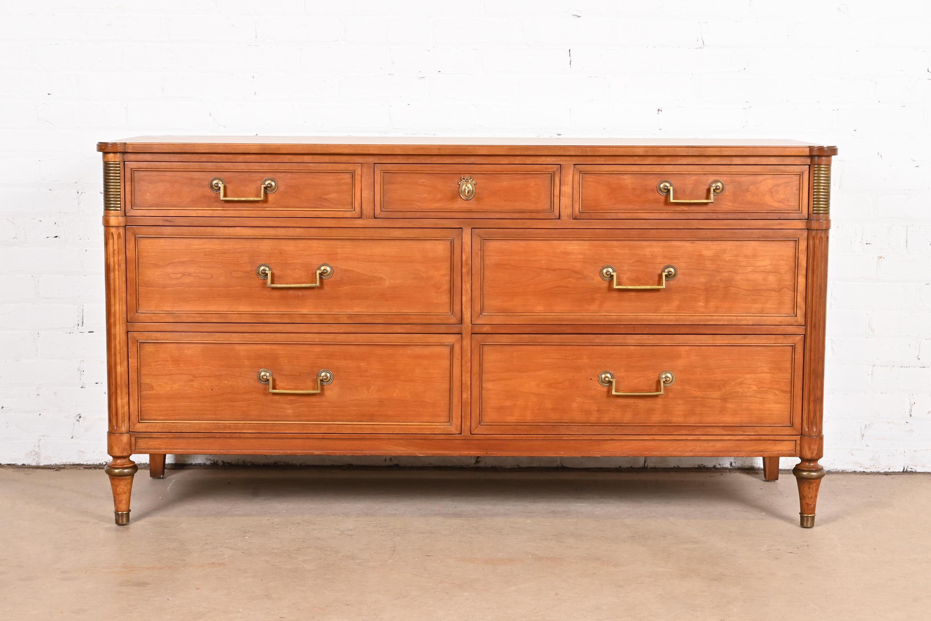 A gorgeous French Regency Directoire style seven-drawer dresser or credenza

By Kindel Furniture

USA, Circa 1960s

Cherry wood, with brass hardware and accents.

Measures: 60.75