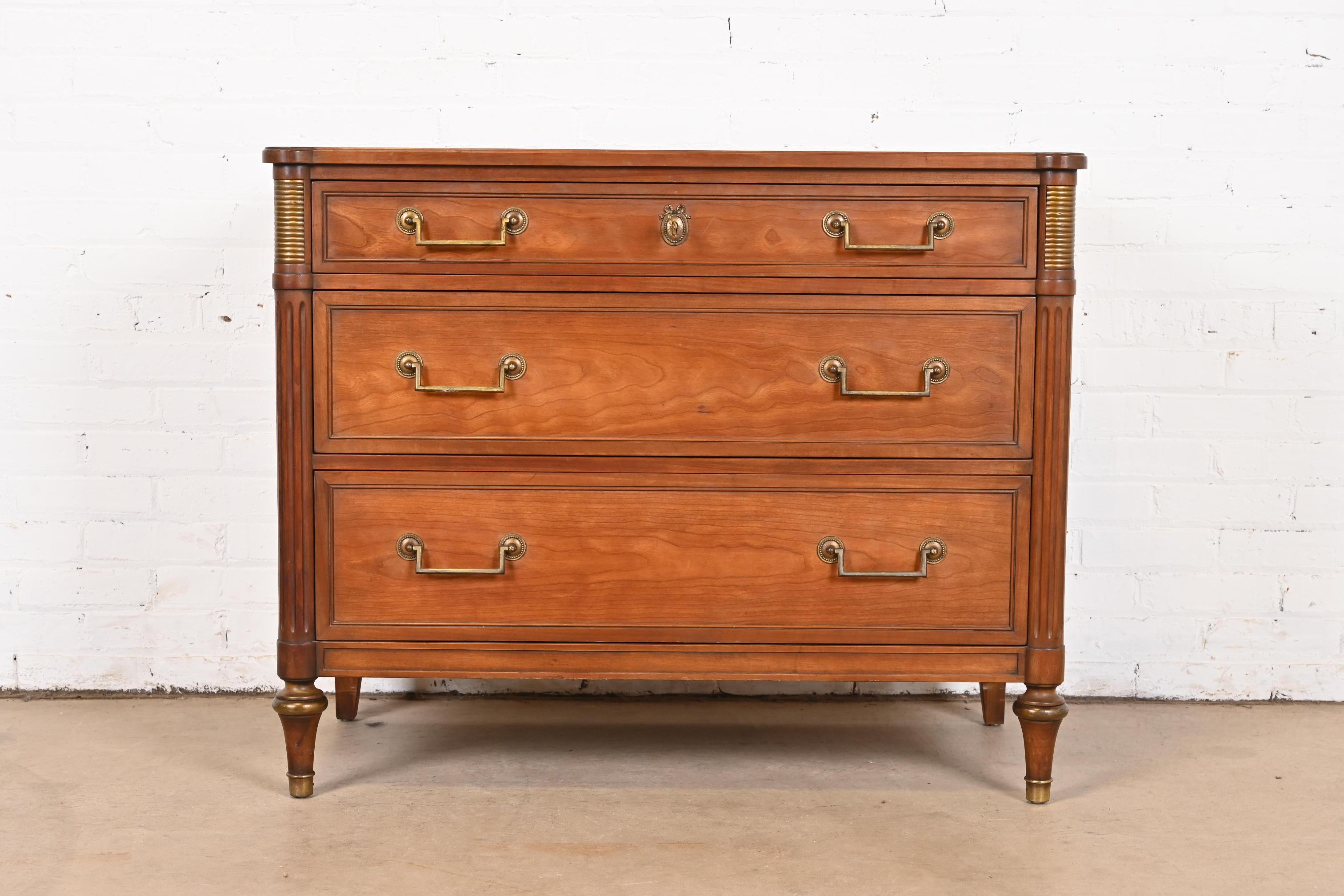 A gorgeous French Regency Louis XVI Directoire style three-drawer dresser or chest of drawers

By Kindel Furniture

USA, Circa 1960s

Cherry wood, with brass hardware and accents.

Measures: 39.75