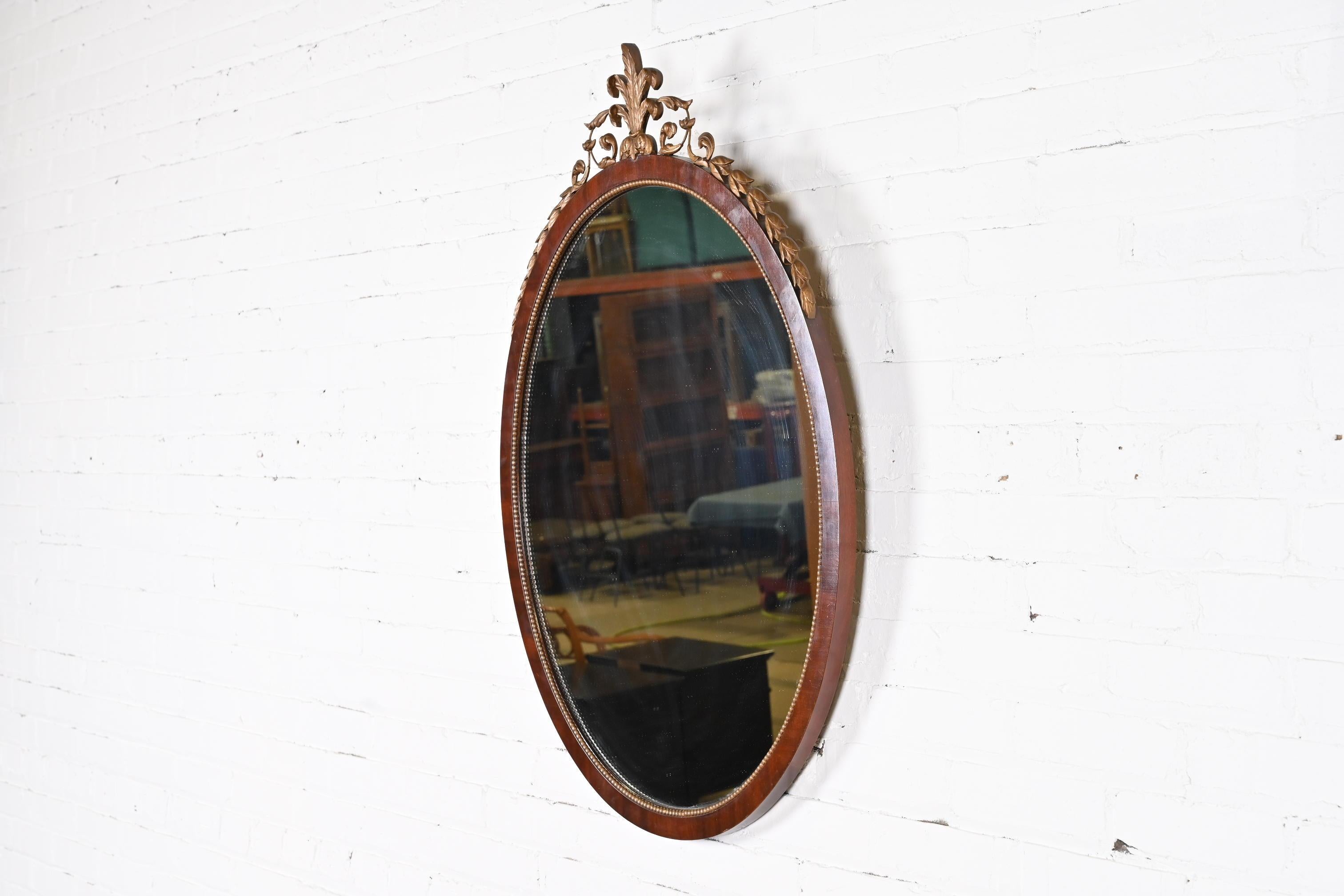A gorgeous French Regency Louis XVI style oval wall mirror

By Kindel Furniture

USA, circa 1960s

Mahogany, with carved giltwood.

Measures: 26