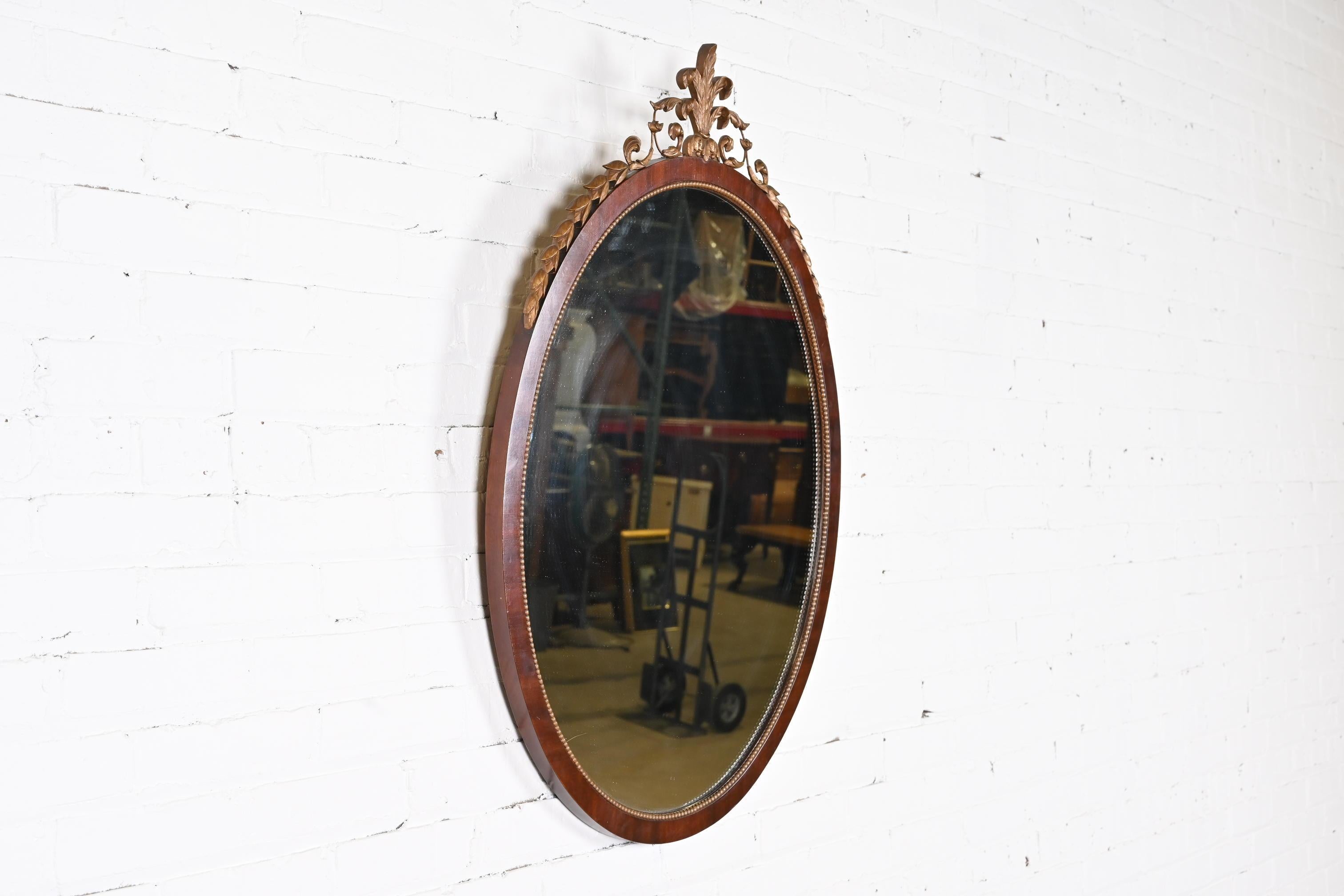 American Kindel Furniture French Regency Louis XVI Mahogany and Giltwood Oval Wall Mirror