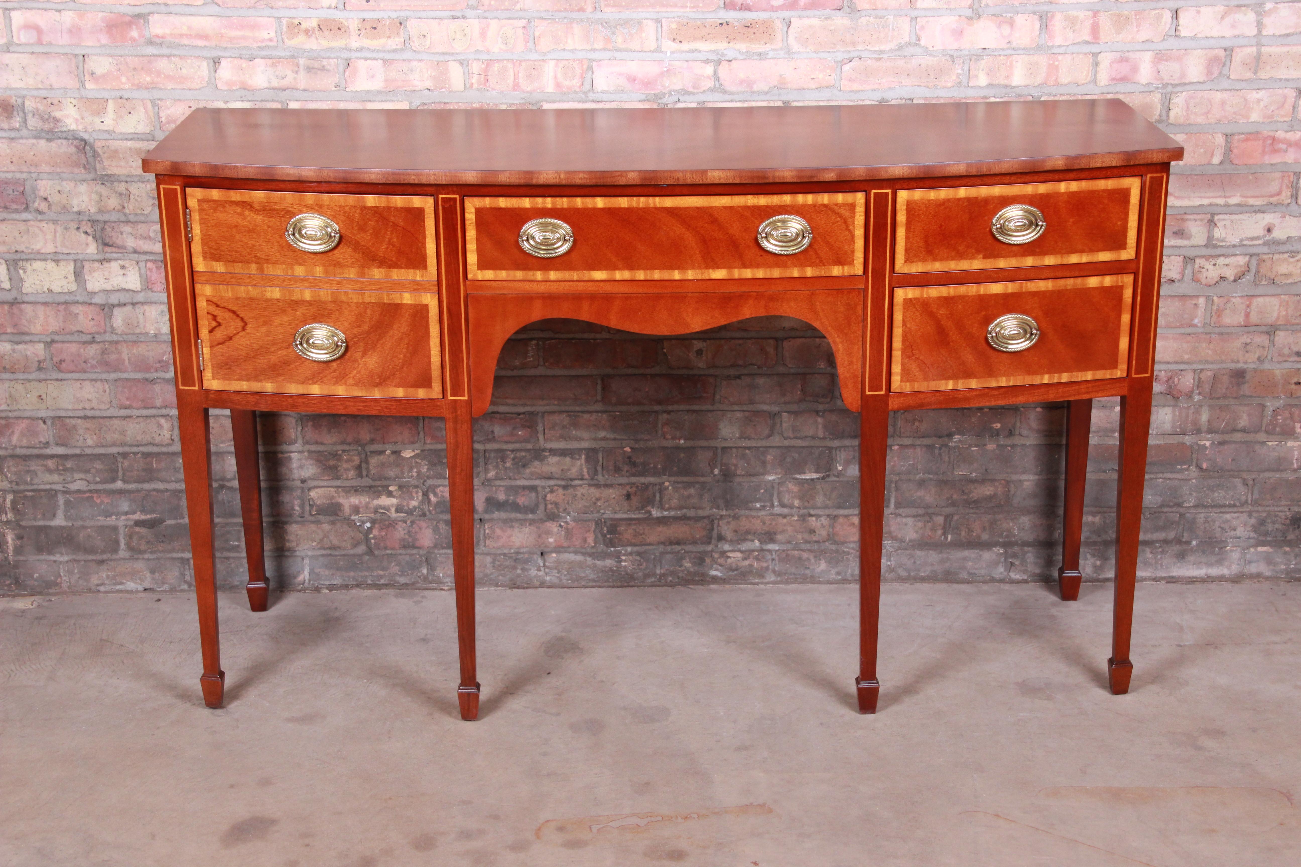 A gorgeous Georgian or Hepplewhite style sideboard buffet or credenza

By Kindel Furniture

USA, circa 1980s

Mahogany, with satinwood banding, original brass hardware, and felt silverware insert.

Measures: 60