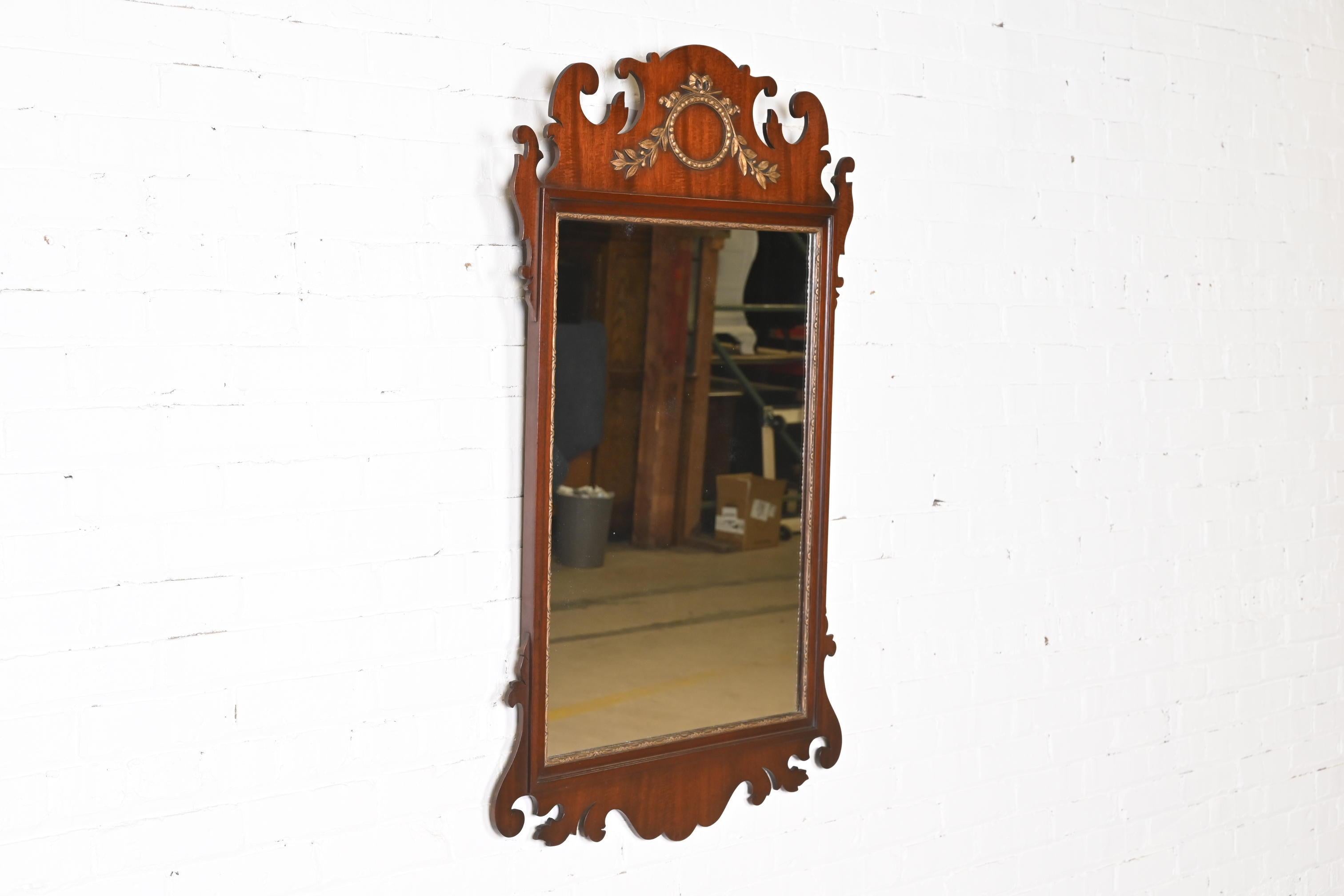 A gorgeous Georgian or Chippendale style wall mirror

By Kindel Furniture

USA, Circa 1980s

Mahogany, with carved gold gilt wreath and trim.

Measures: 29