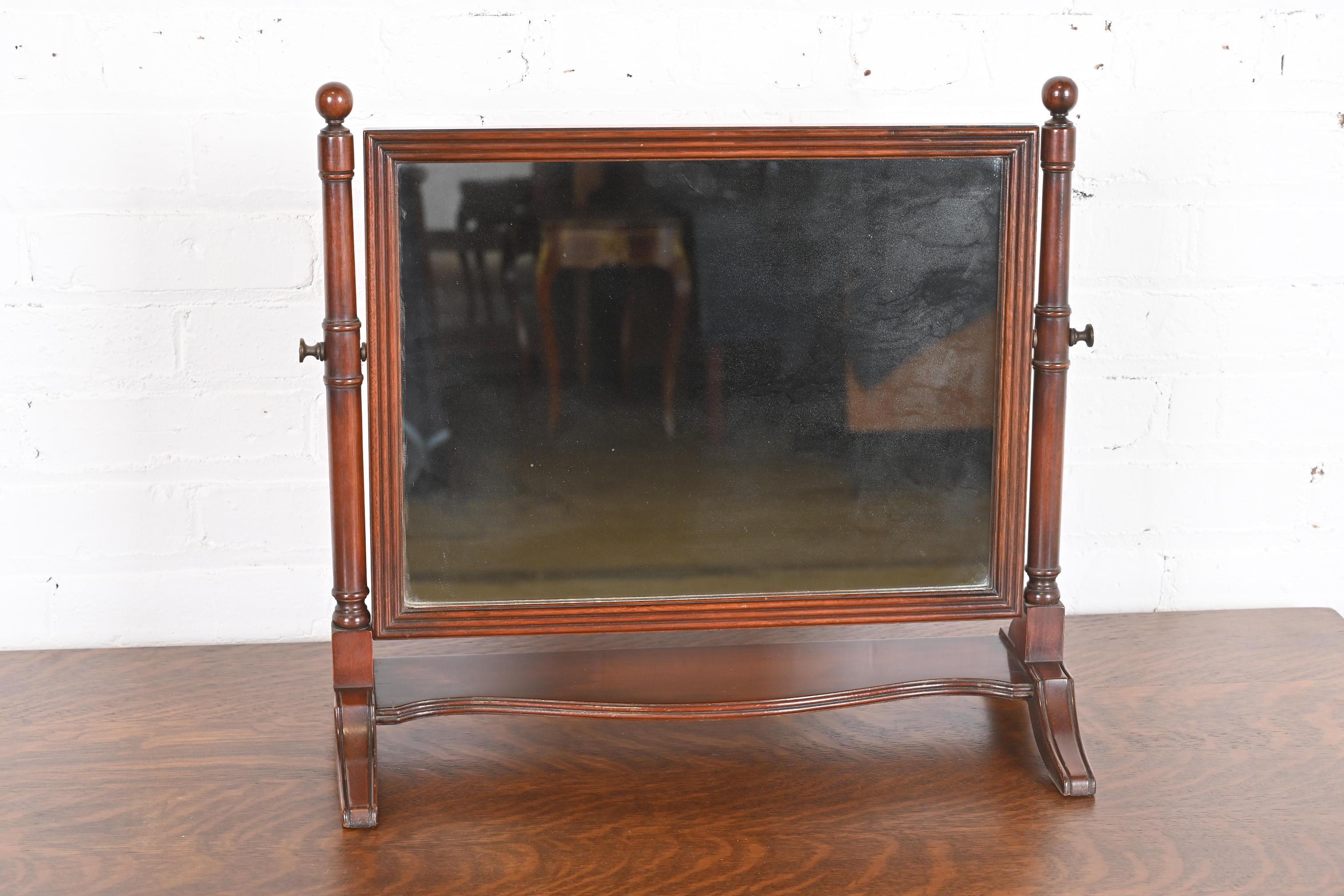 A gorgeous Georgian or Chippendale style dresser top or vanity swing mirror

By Kindel Furniture

USA, Circa 1960s

Carved mahogany, with brass hardware.

Measures: 20.38