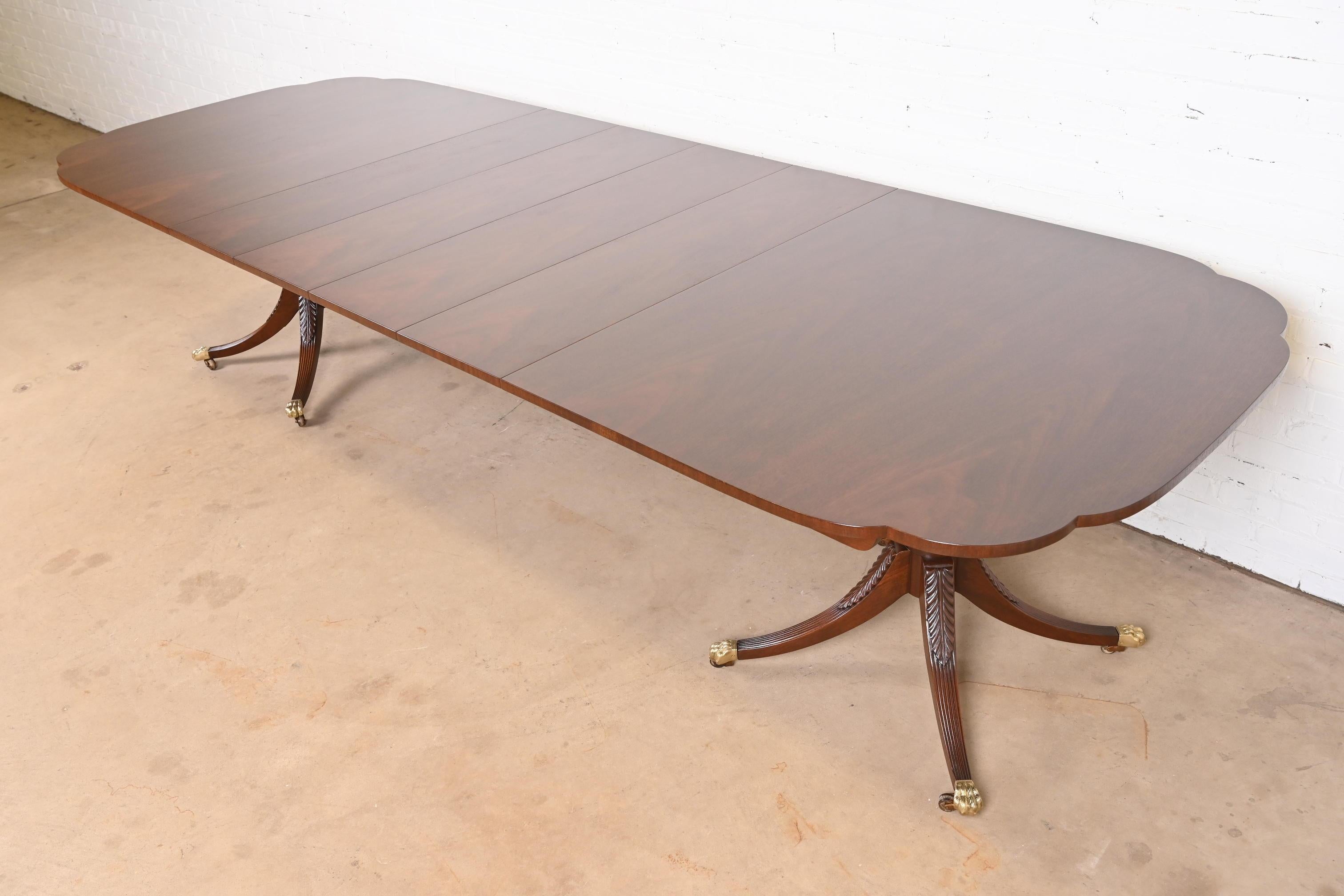 A gorgeous Georgian or Regency style double pedestal extension dining table

By Kindel Furniture

USA, Circa 1980s

Beautiful book-matched mahogany, with scalloped corners, carved mahogany legs, and brass-capped paw feet on brass casters.

Measures: