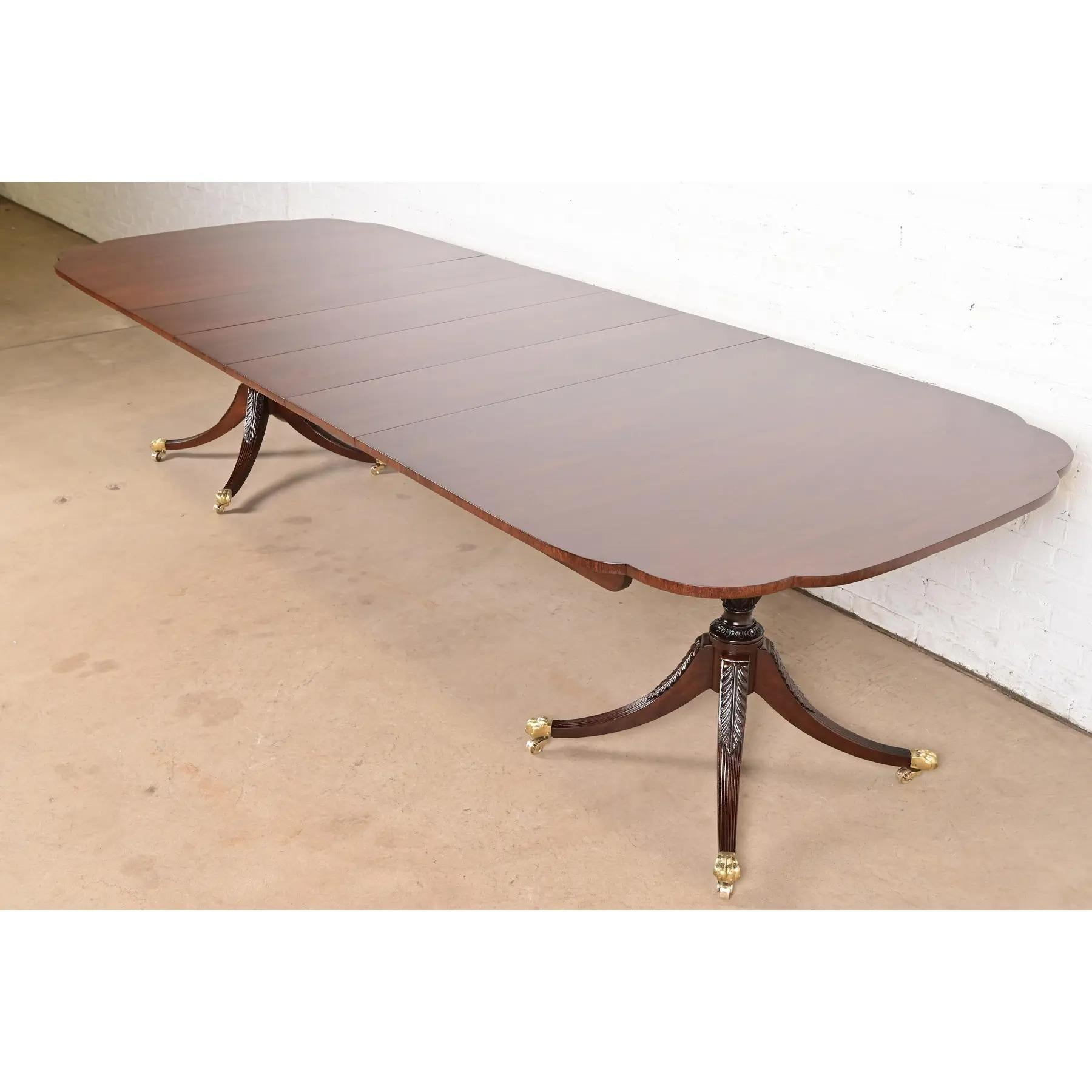 A gorgeous Georgian or Regency style double pedestal extension dining table

By Kindel Furniture

USA, Circa 1980s

Solid mahogany, with scalloped corners, carved pedestals, brass paw feet, and brass casters. A unique design, with leaves that store