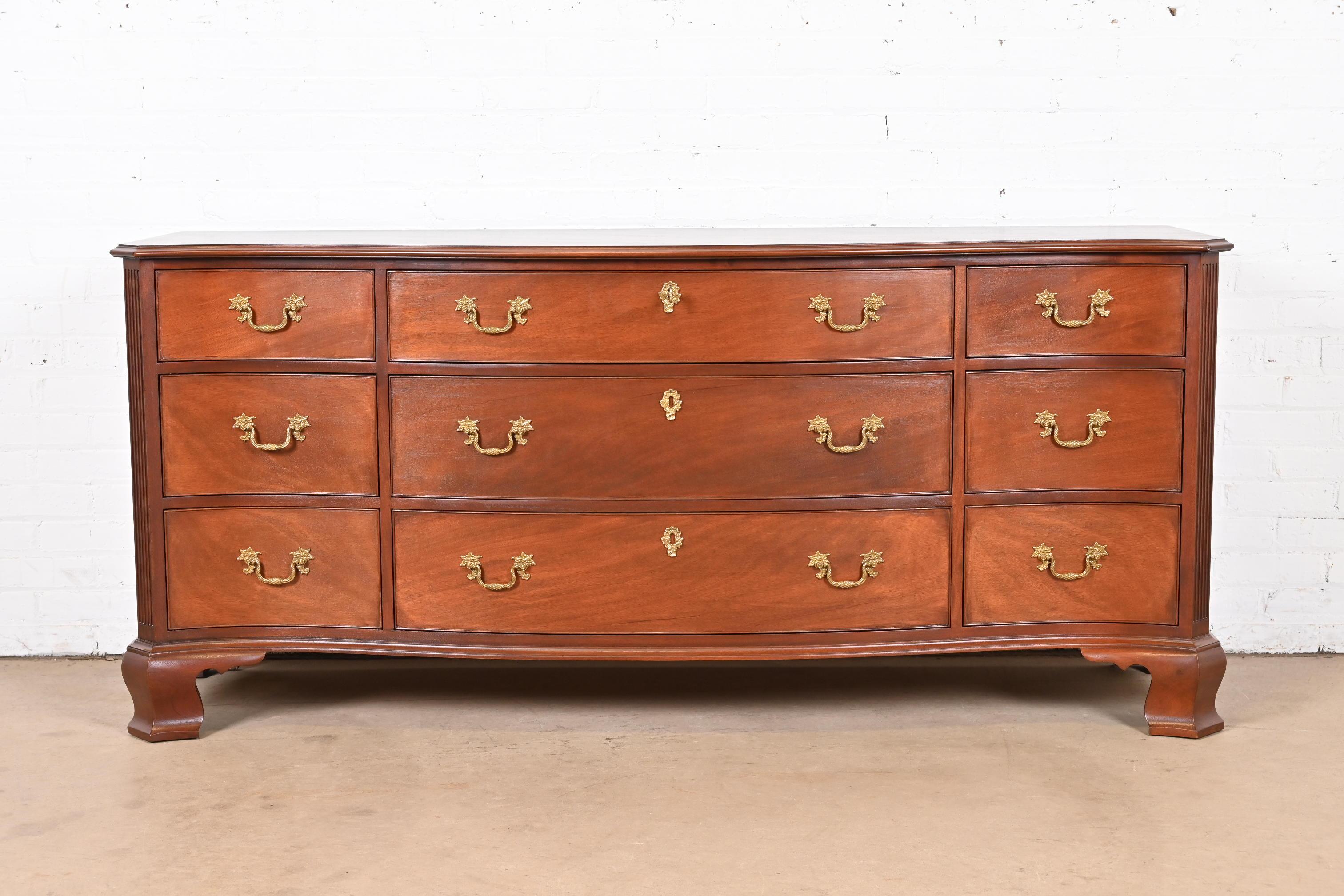 An exceptional Georgian or Chippendale style serpentine front triple dresser, chest of drawers, or credenza

By Kindel Furniture

USA, Circa 1980s

Gorgeous carved mahogany, with original brass hardware.

Measures: 72.25