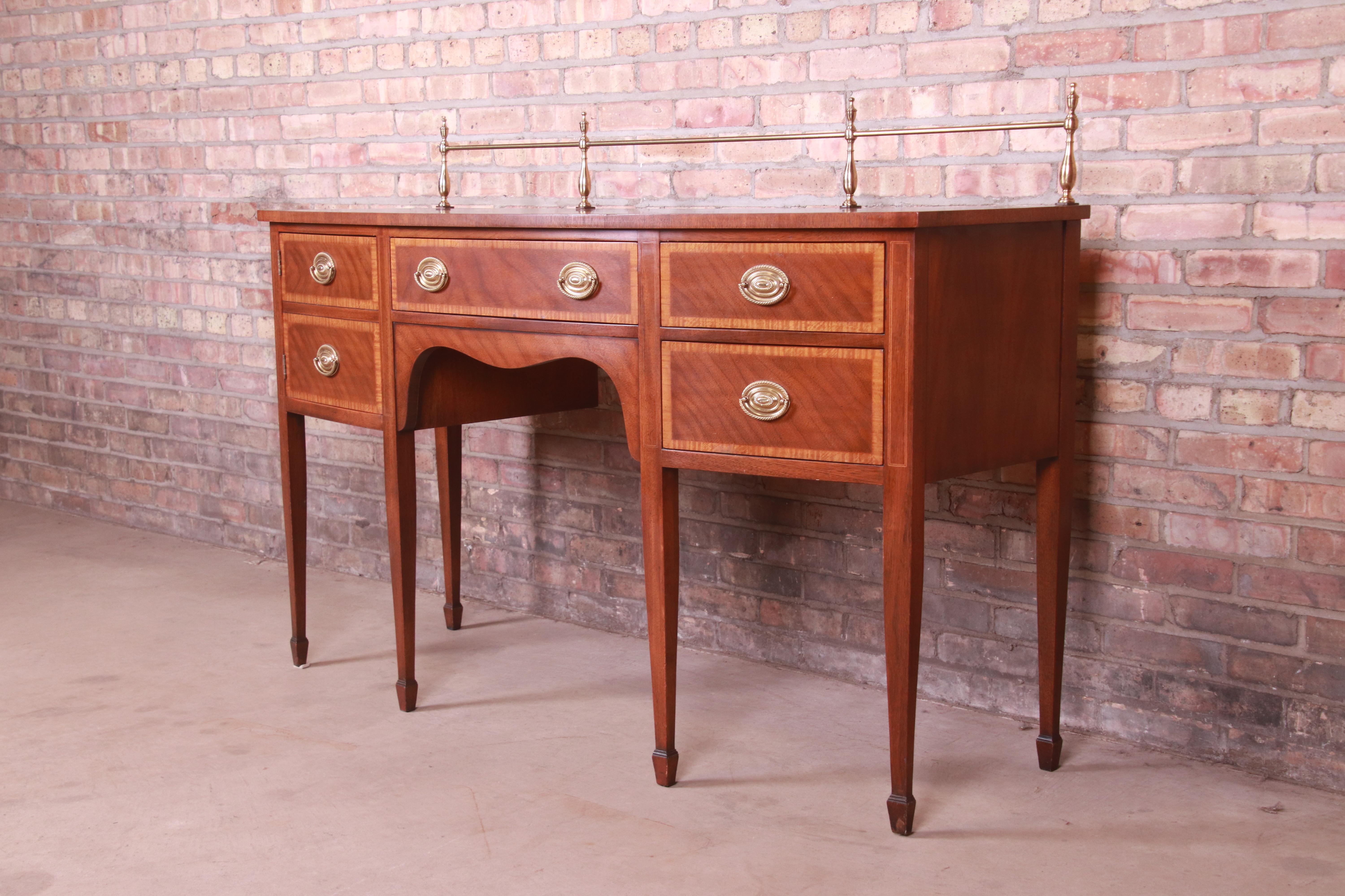 A gorgeous Hepplewhite or Federal style sideboard, buffet, or credenza

By Kindel Furniture

USA, Circa 1980s

Mahogany, with satinwood banding, and original brass hardware and gallery.

Measures: 60