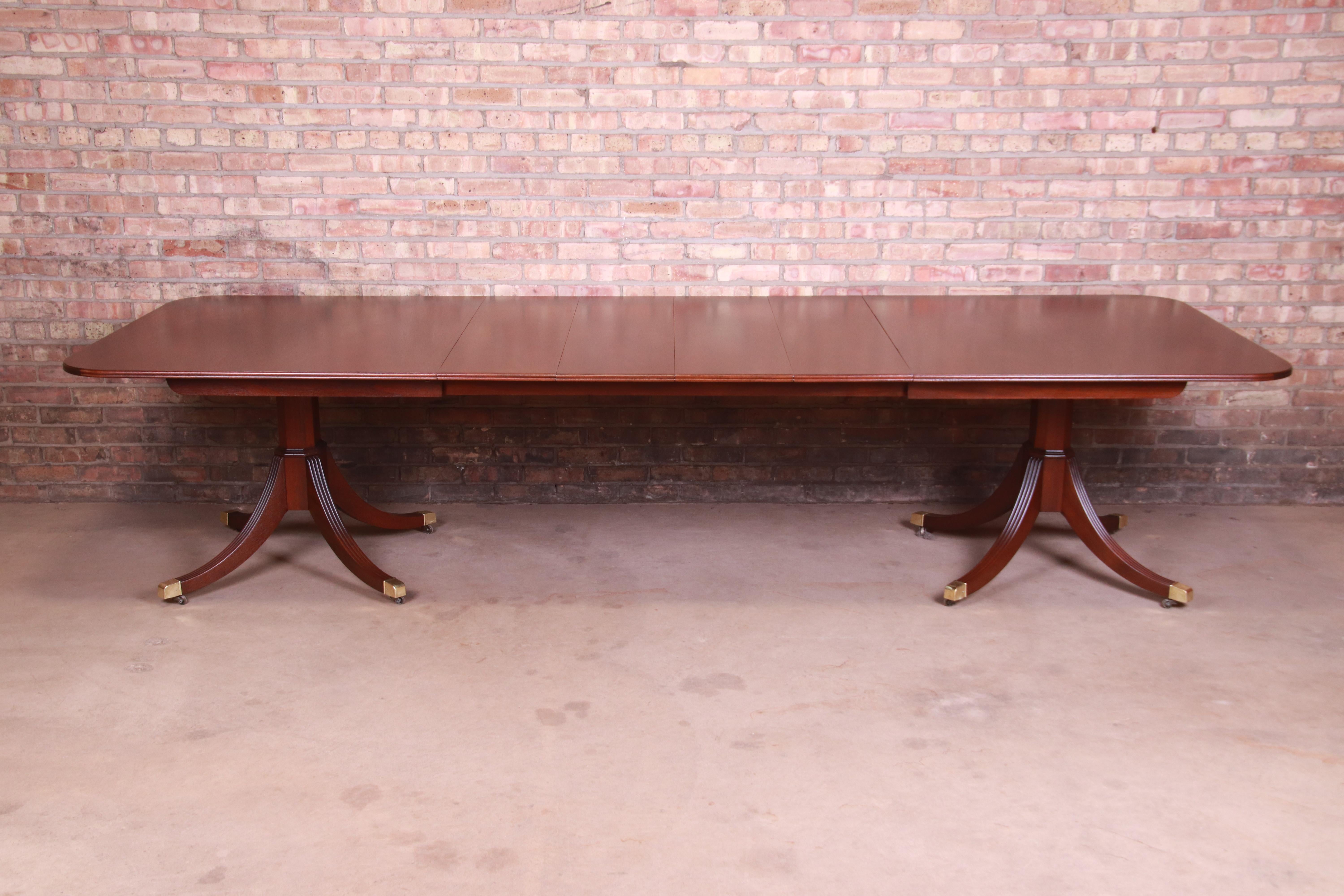 An exceptional Irish Georgian style double pedestal extension dining table

By Kindel Furniture

USA, Circa 1980s

Book-matched mahogany top, carved solid mahogany pedestals, and brass-capped feet.

Measures: 78