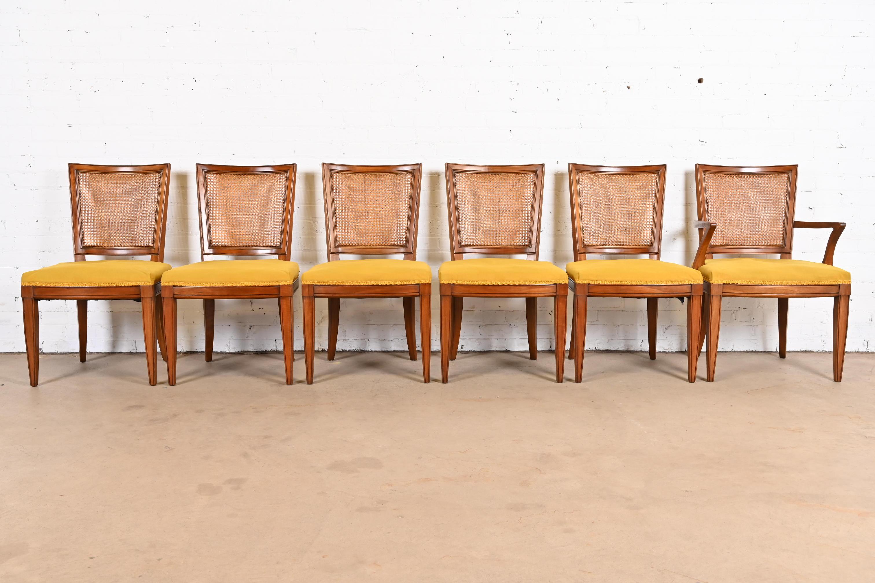 A gorgeous set of six midcentury French Regency Louis XVI style dining chairs

By Kindel Furniture

USA, 1960s

Solid carved cherry wood frames, with cane backs, and yellow upholstered seats.

Measures:
Side chairs - 20.25