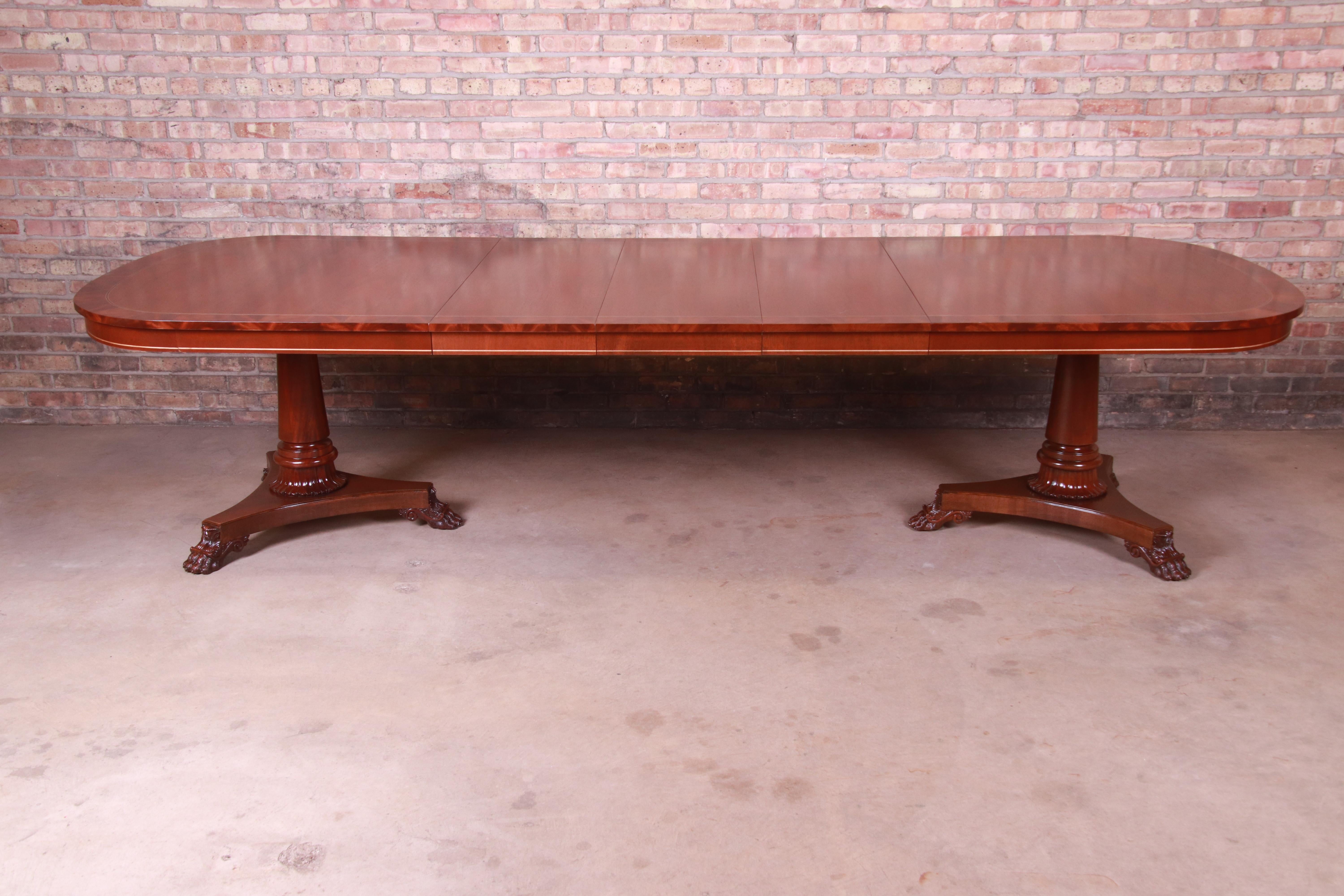 An exceptional neoclassical double pedestal extension dining table

By Kindel Furniture

USA, 1990s

Book-matched mahogany, with flame mahogany banding and carved solid mahogany column pedestals with paw feet.

Measures: 80