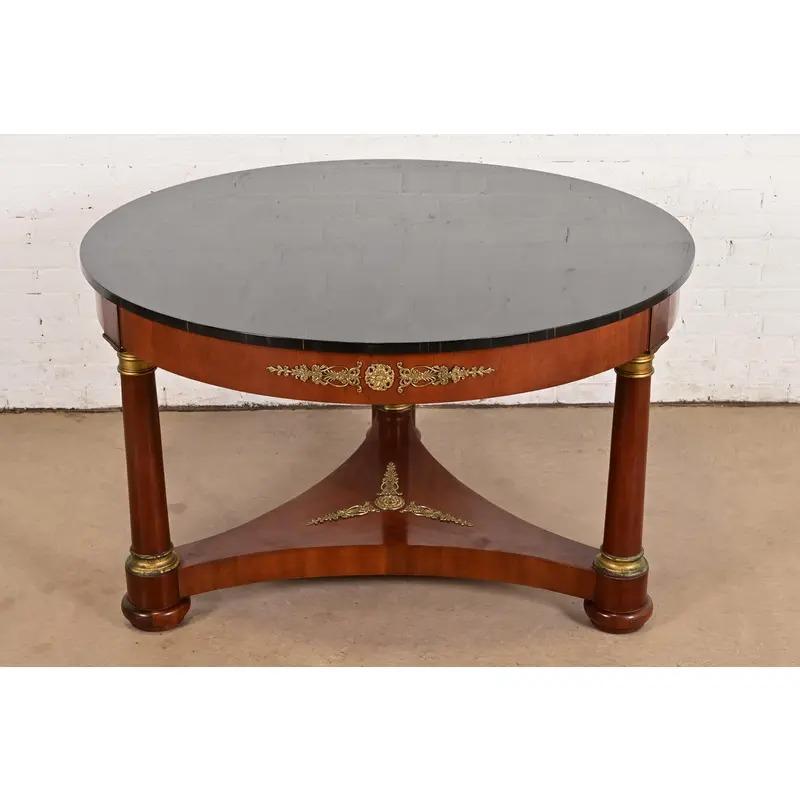An exceptional Neoclassical or French Empire style center table or dining table

By Kindel Furniture

USA, 1990s

Gorgeous carved mahogany, with lacquered faux marble top, and mounted brass ormolu.

Measures: 48