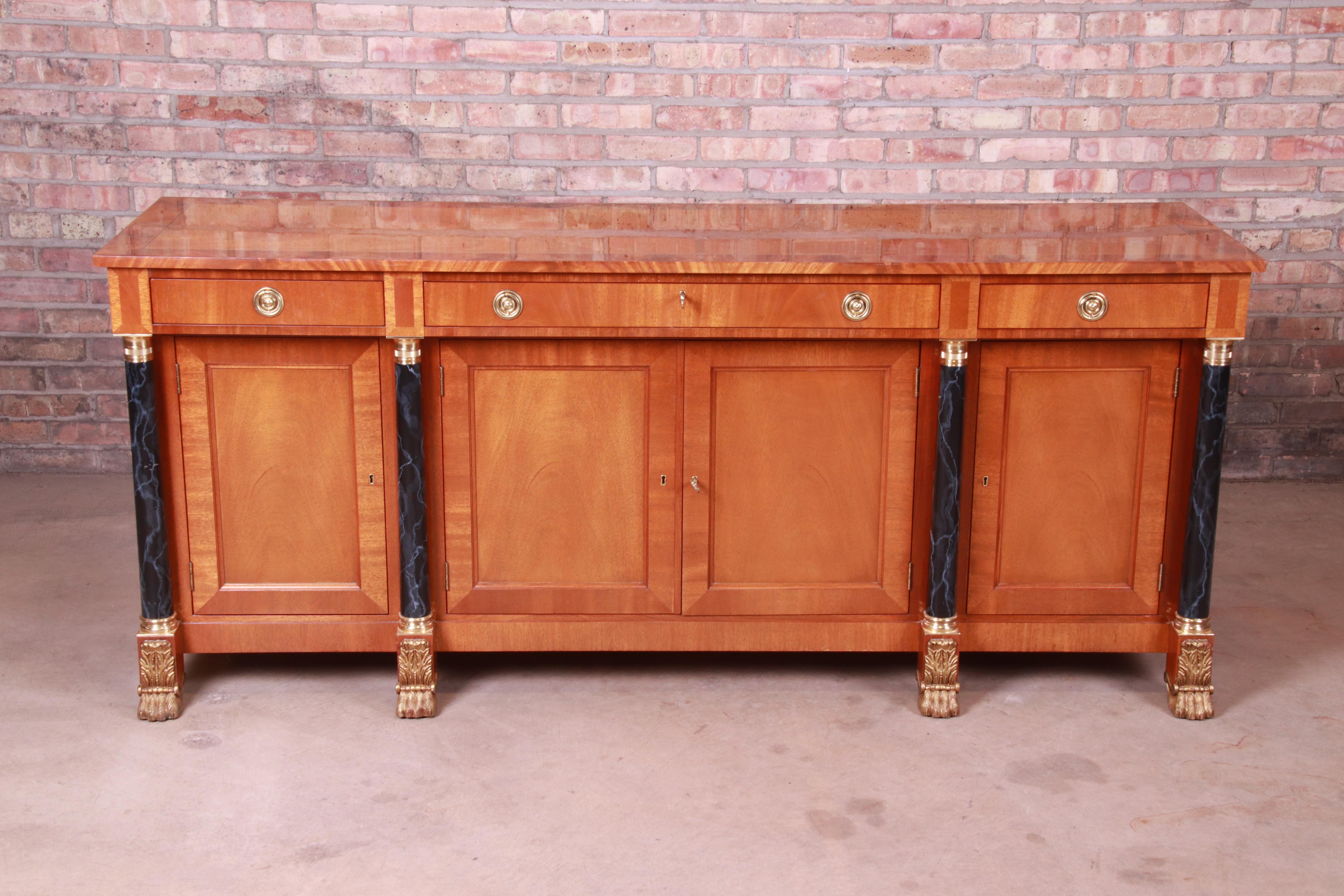 An exceptional neoclassical or Empire style sideboard, credenza, or bar cabinet

By Kindel Furniture

USA, late 20th century

Mahogany, with painted faux marble columns and original brass hardware and paw feet.

Measures: 75.75