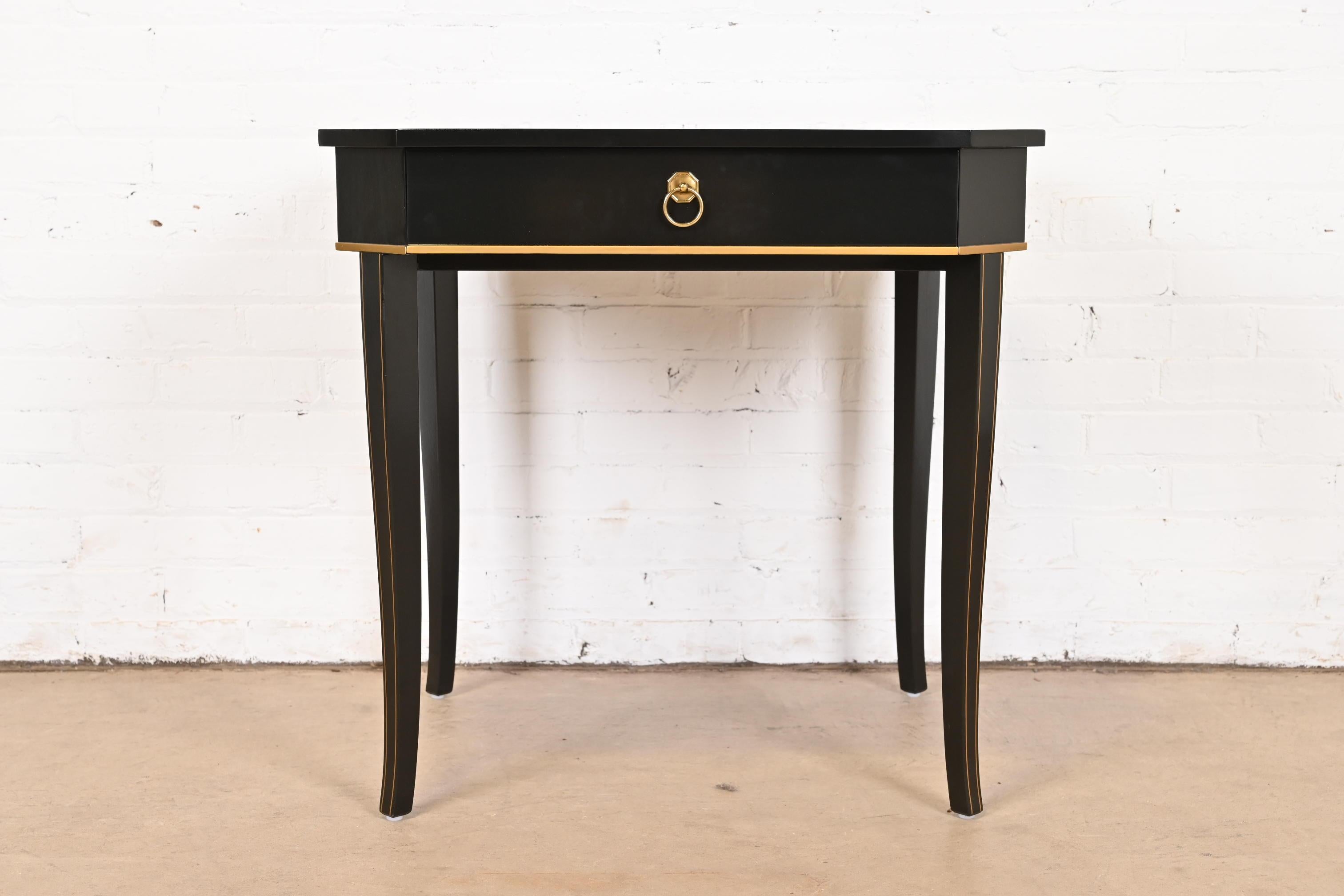 A gorgeous Regency style tea table or occasional side table

By Kindel Furniture

USA, Late 20th Century

Black lacquered mahogany, with gold gilt trim and original brass hardware.

Measures: 28