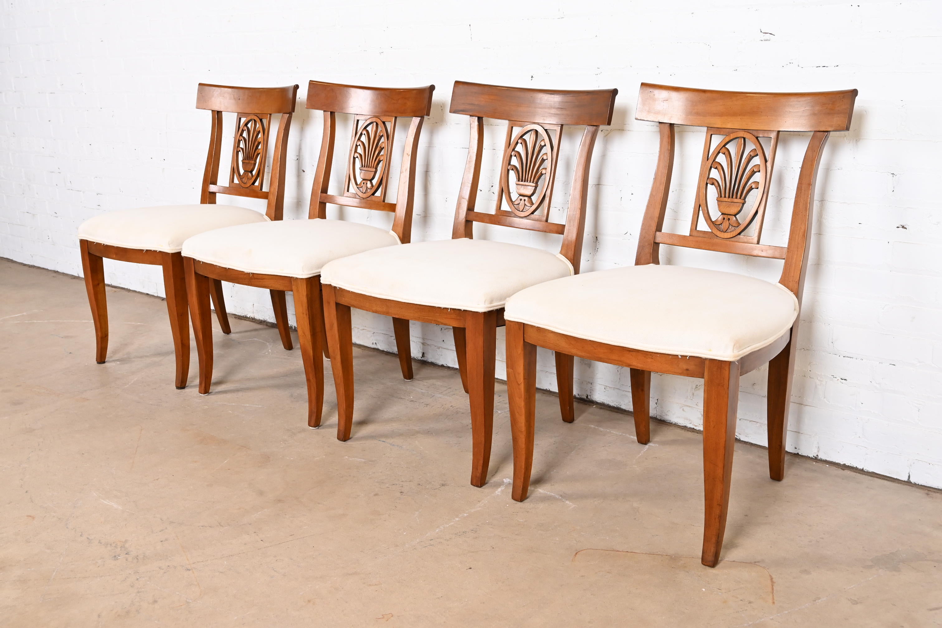 A gorgeous set of four Regency or Neoclassical style dining chairs

By Kindel Furniture

USA, Circa 1980s

Carved fruitwood frames, with white upholstered seats.

Measures: 20.5