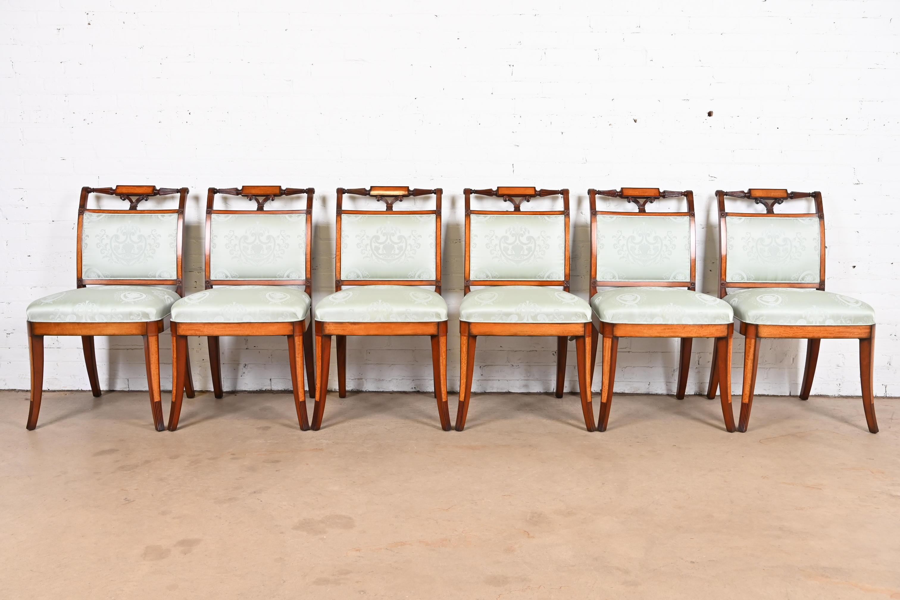 A gorgeous set of six Regency style dining chairs

By Kindel Furniture

USA, Late 20th Century

Carved mahogany and satinwood frames, with light blue silk upholstered seats.

Measures: 21